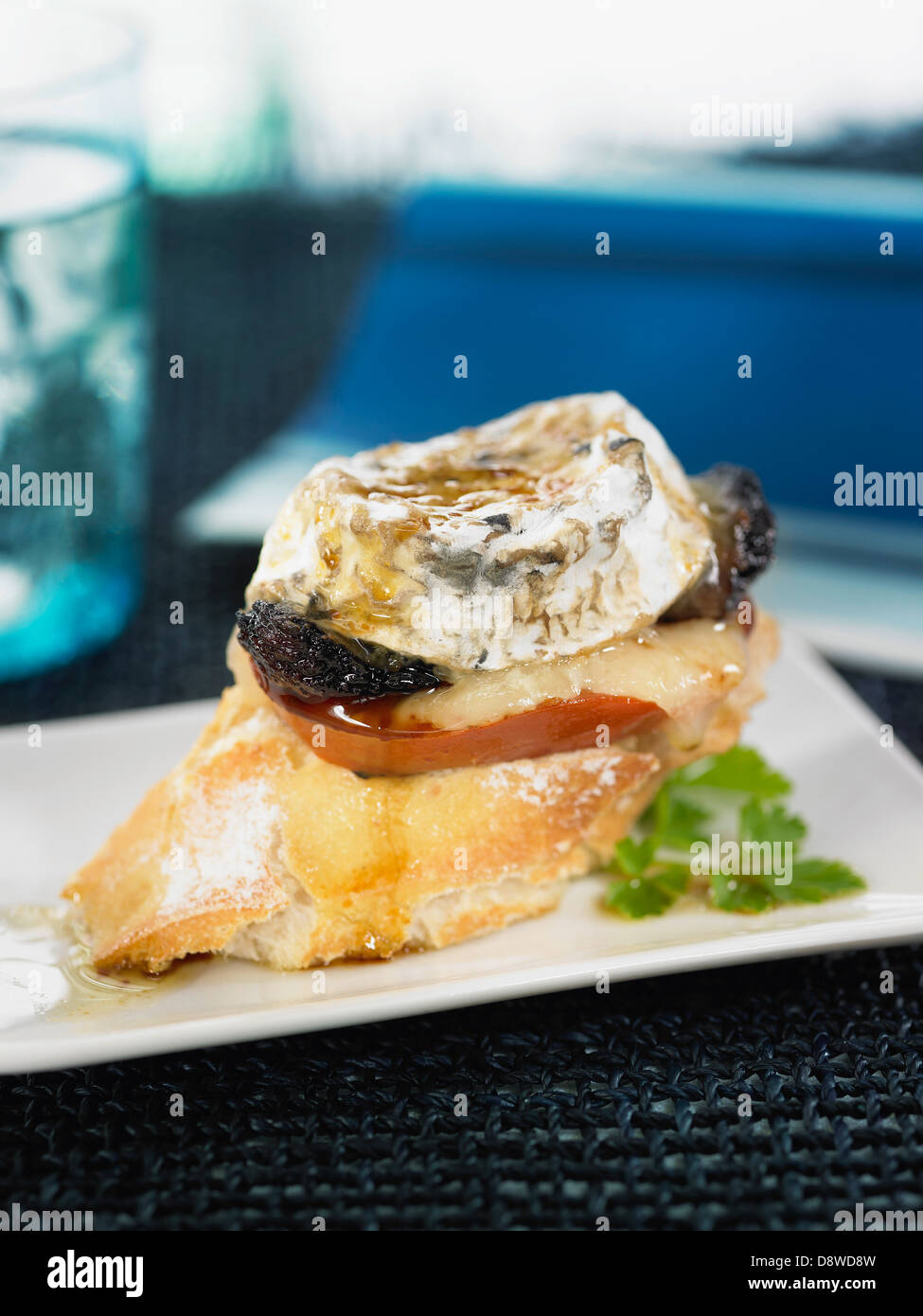 Blood sausage,goat's cheese and tomato on bread with vinaigrette Stock Photo