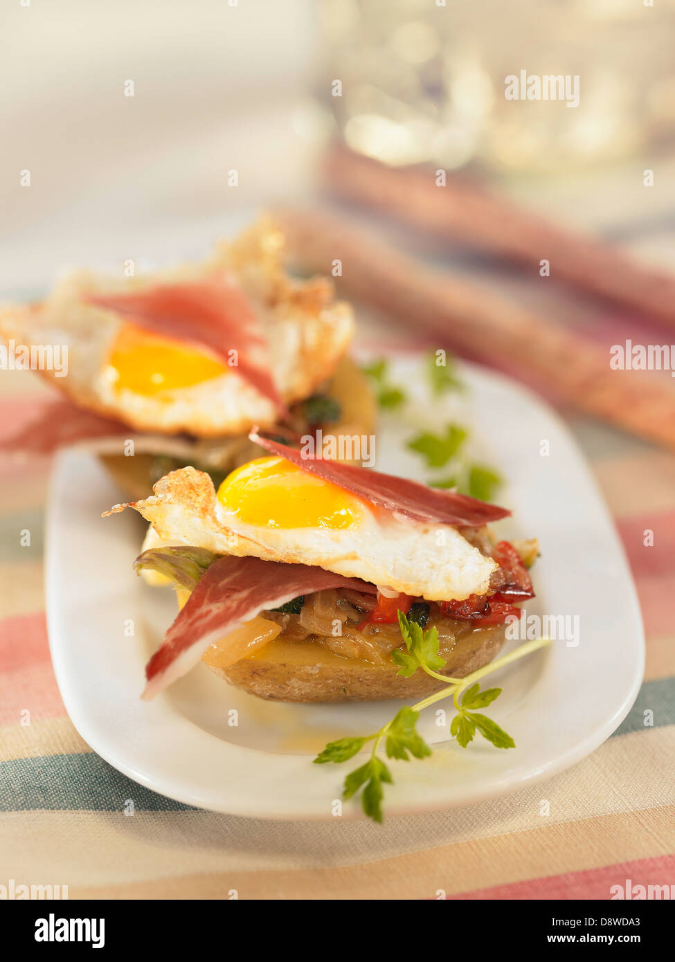 Potato with pesto,fried quail's egg and Serrano ham Stock Photo