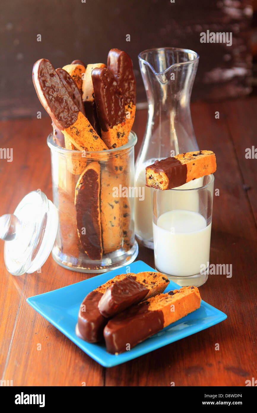 Raisin Croquants dipped in chocolate,glass and jug of milk Stock Photo