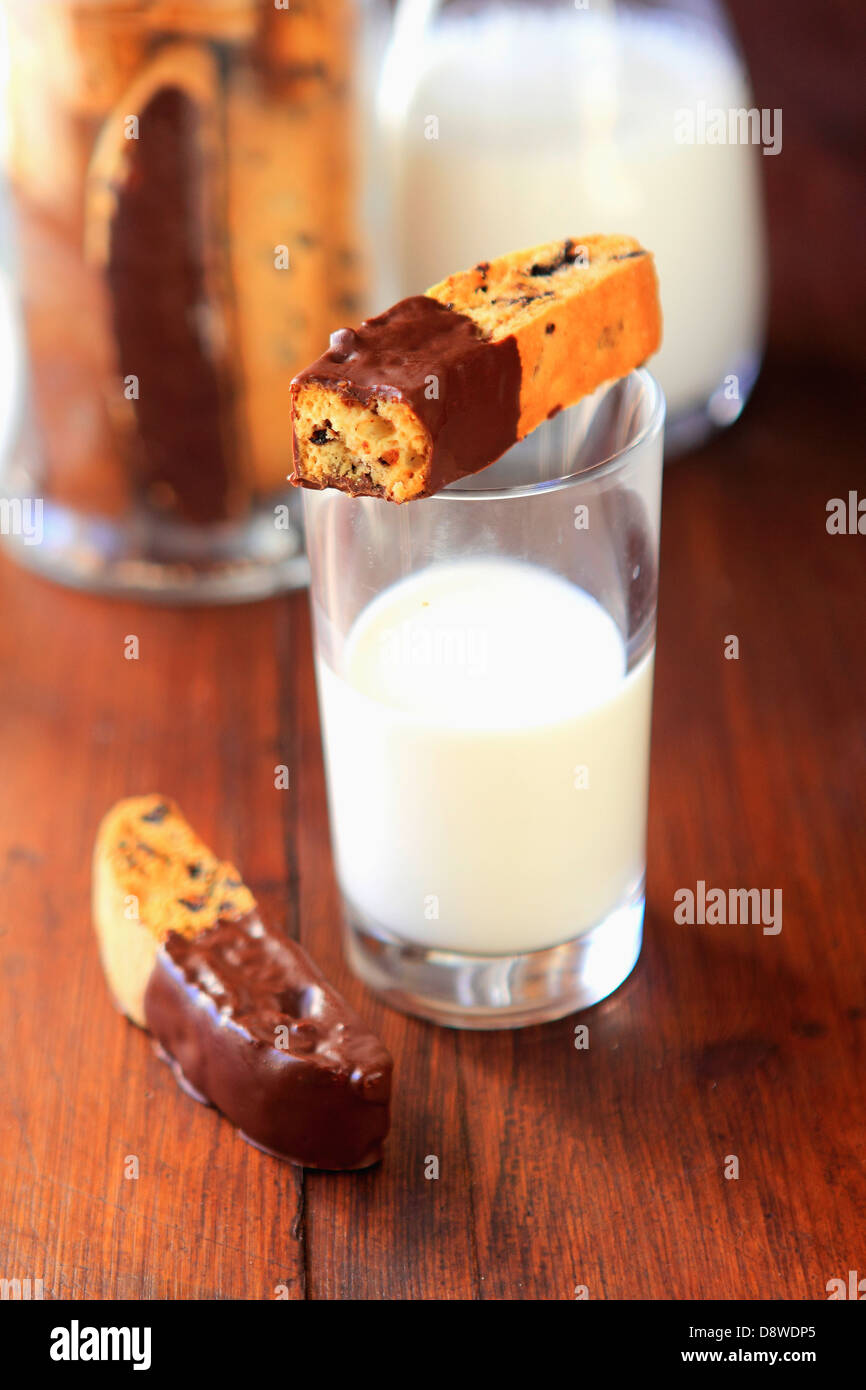 Raisin Croquants dipped in chocolate,glass and jug of milk Stock Photo