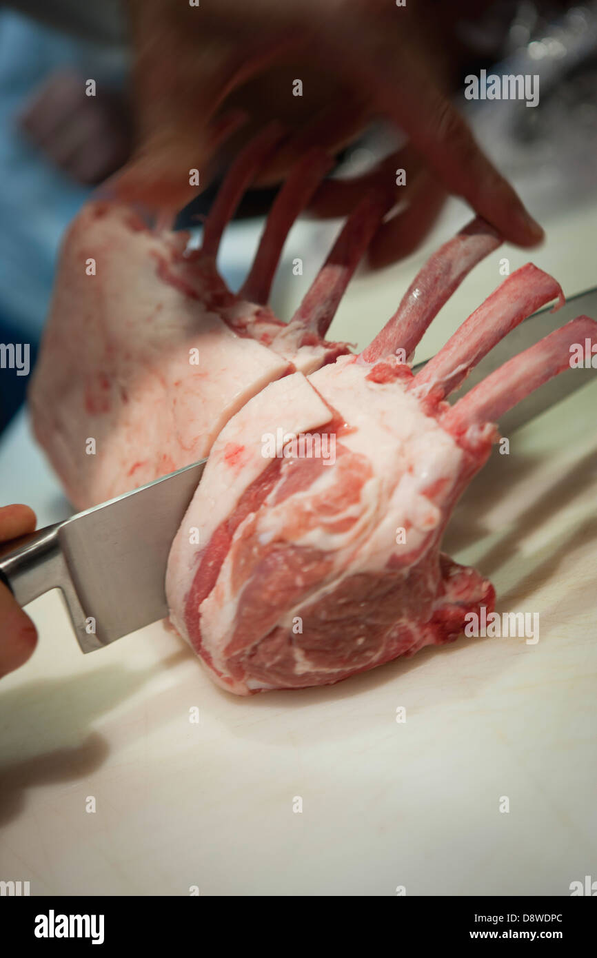 Cutting lamb chops Stock Photo
