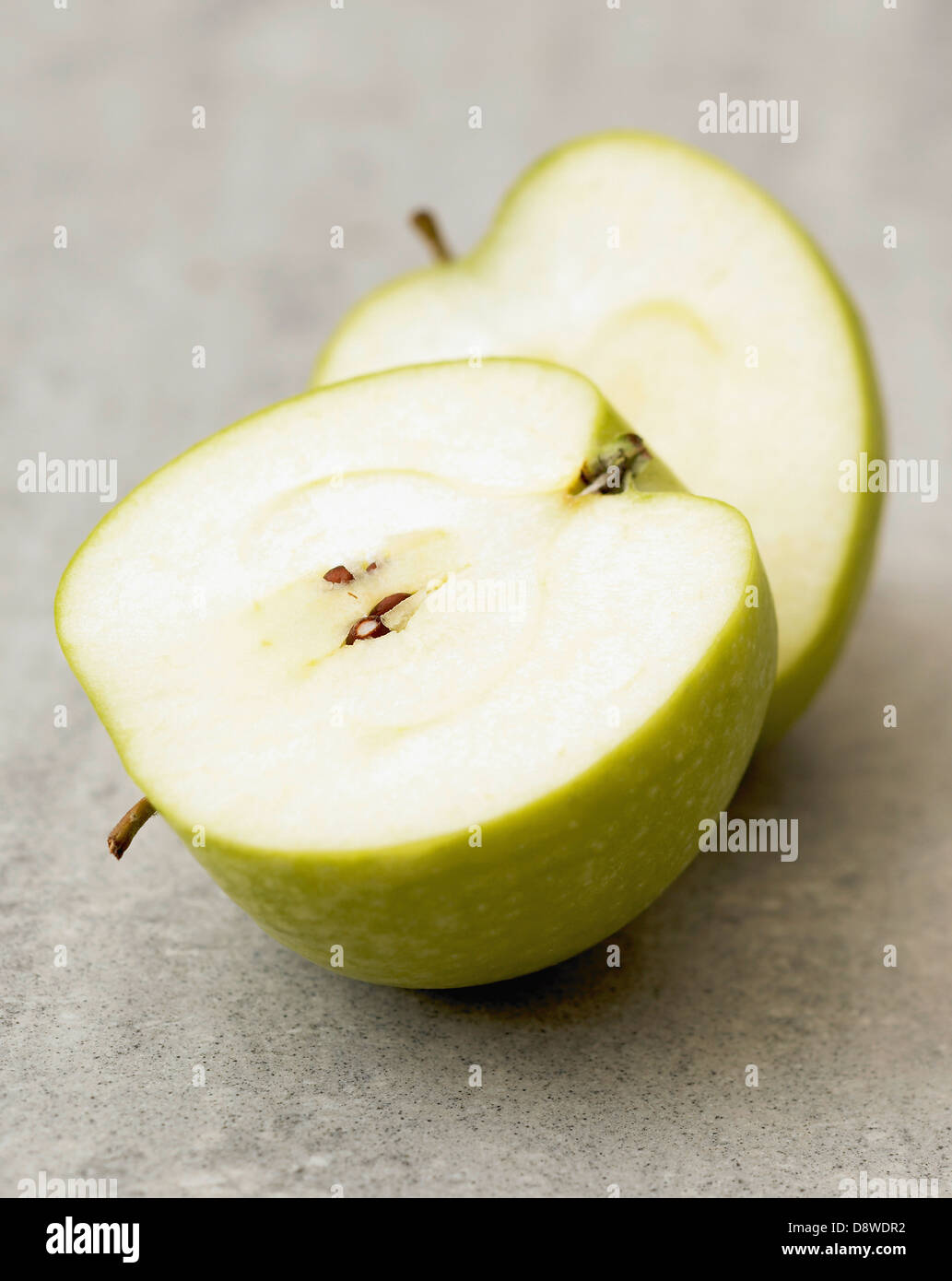 Granny Smith apple cut in half Stock Photo