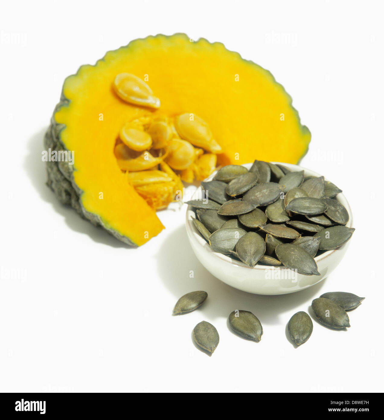 Slice of squash and dried squash seeds Stock Photo Alamy