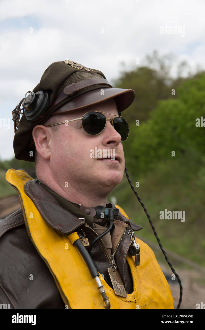 A color image of a reenactor dressed as a WW2 bomber pilot looking skyward. Stock Photo