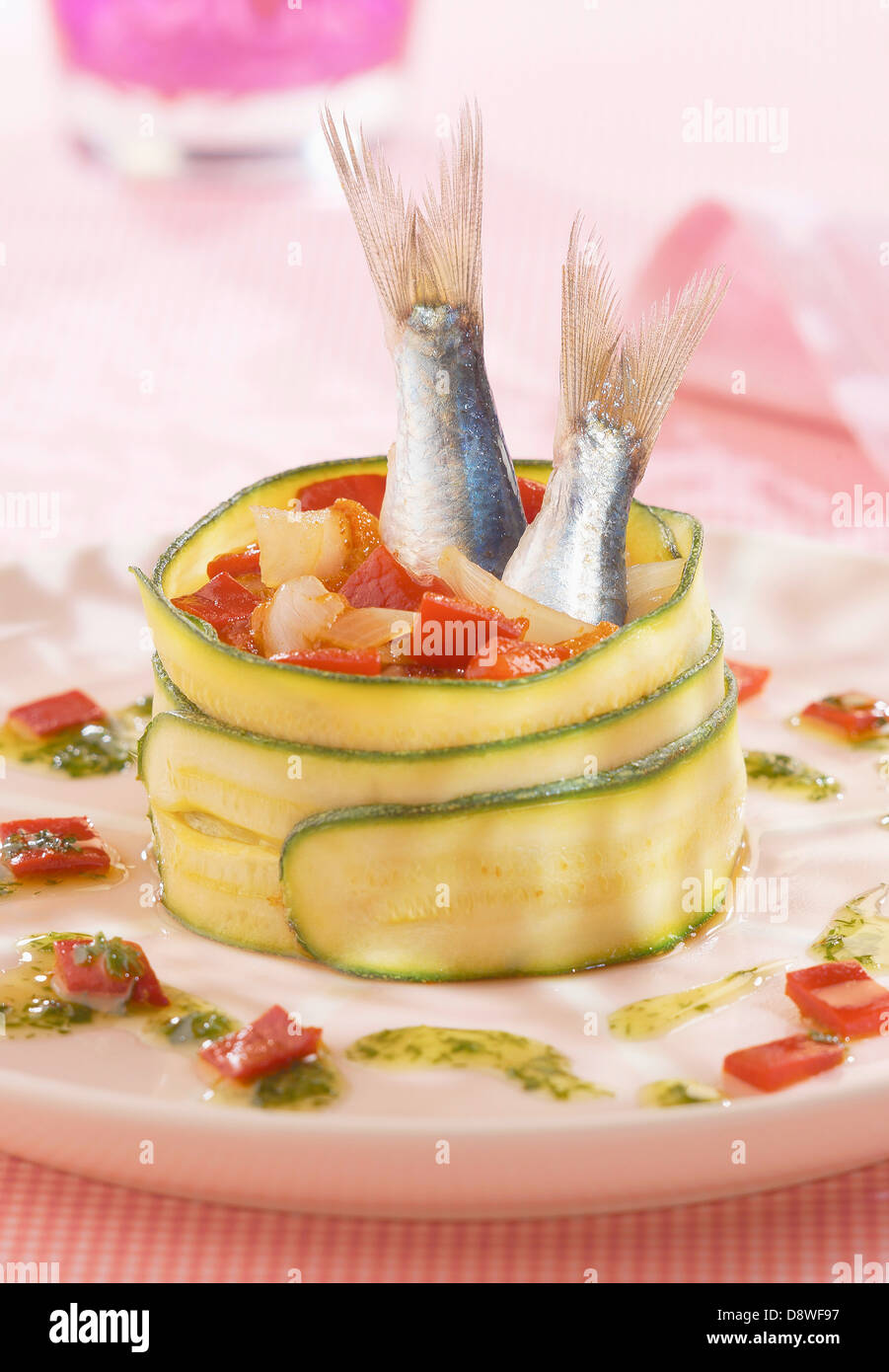 Zucchini roll garnished with red peppers and sardines Stock Photo Alamy