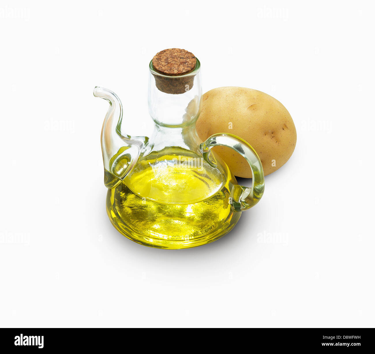 Small bottle of oil and a potato Stock Photo