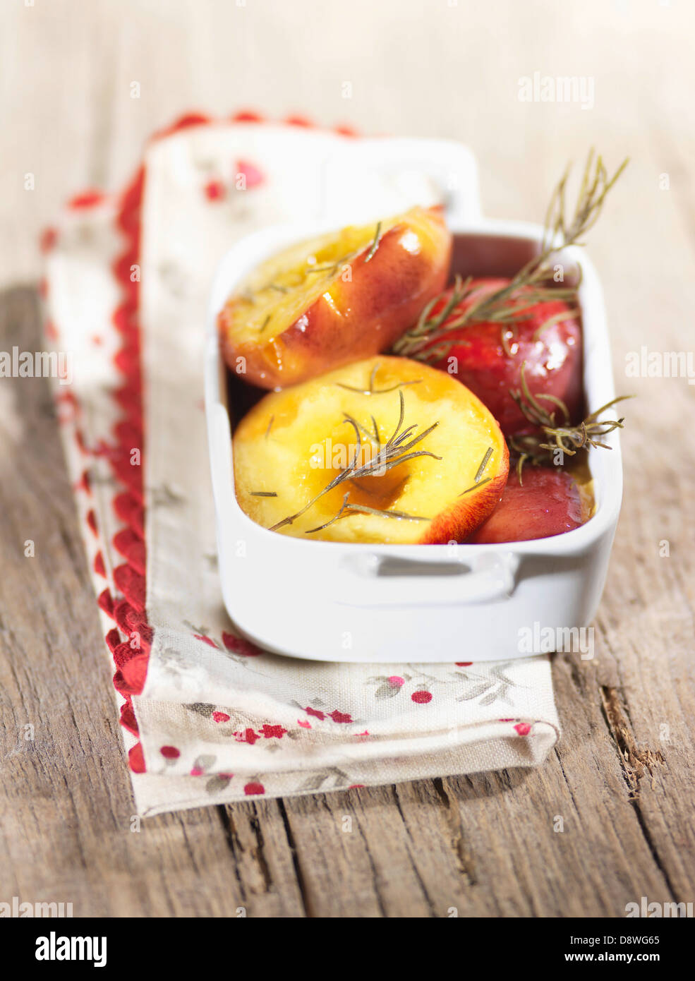 Roasted peaches with rosemary Stock Photo