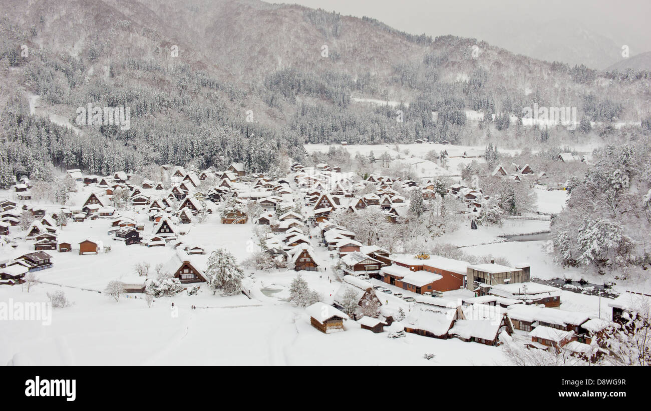 View of Snow Covered Shirakawa Ogimachi Village from atop a nearby Mountain in the afternoon. Stock Photo