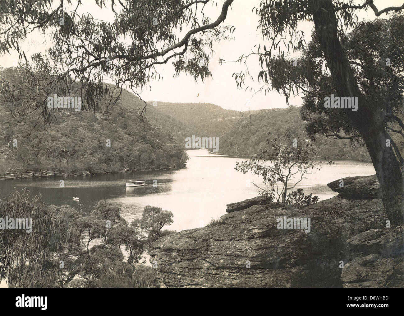 The image shows Berowra Waters, located along the Hawkesbury River in New South Wales. Captured in black and white, the photograph features boats navigating the river and bushland along the North Shore. Stock Photo
