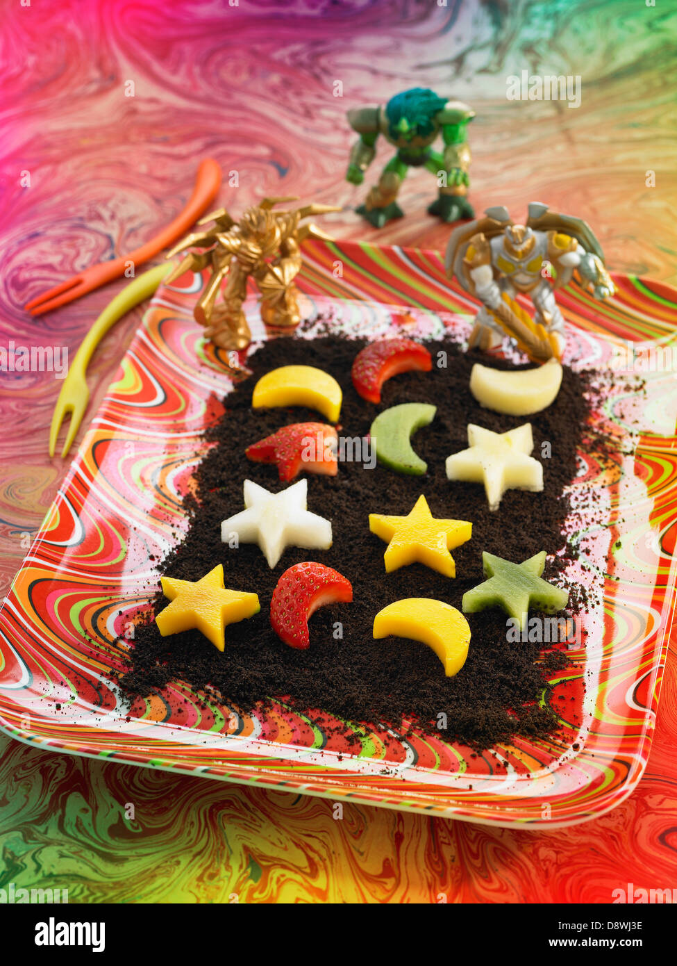 Star and moon shaped fresh fruit on a bed of crumbles chocolate