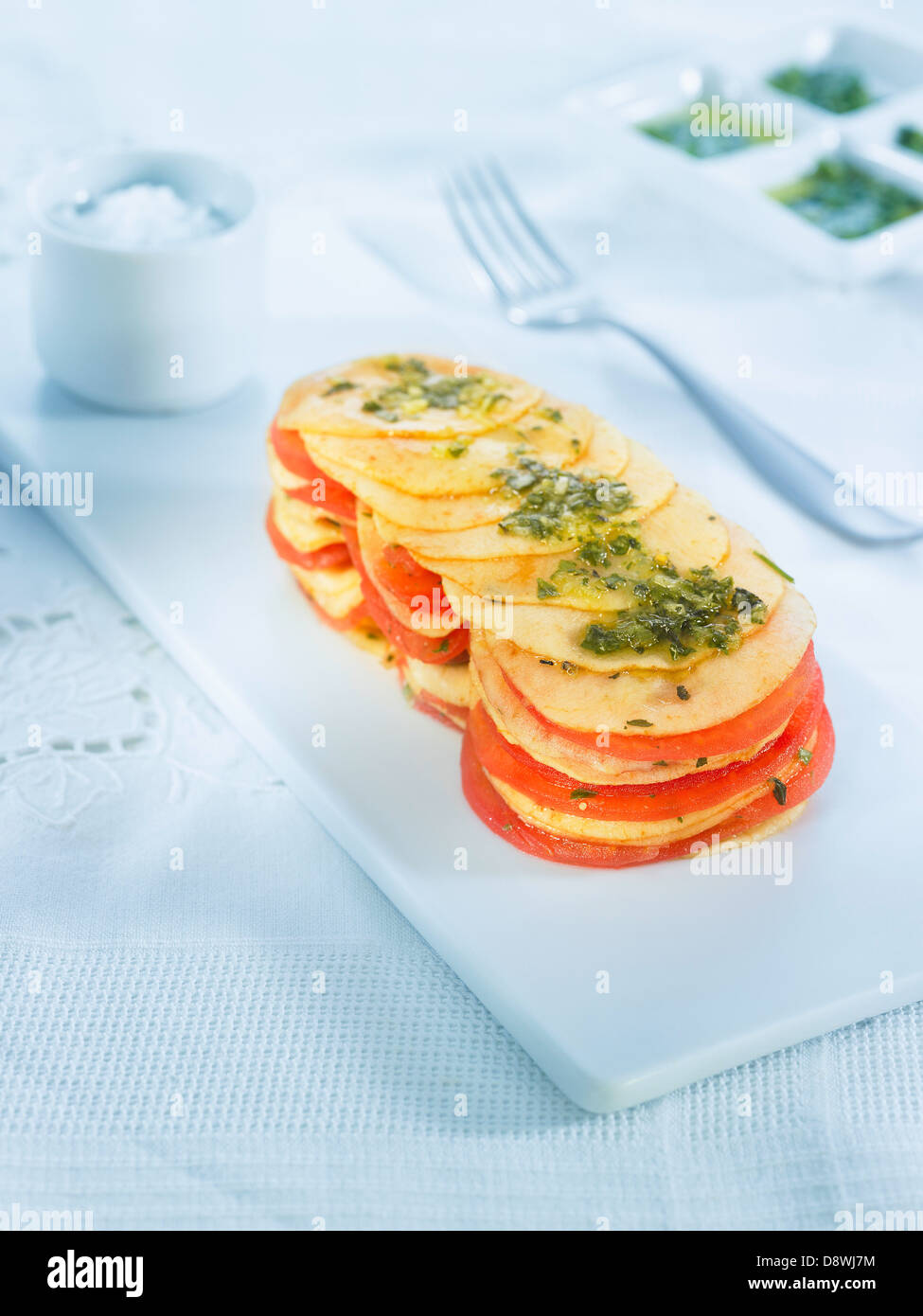 Sliced apple and tomato mille-feuille with parsley Stock Photo