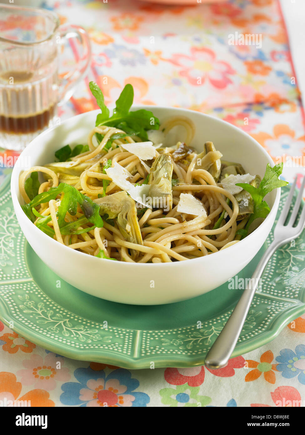 Spelt spaghetti with artichokes,honey and lemon Stock Photo