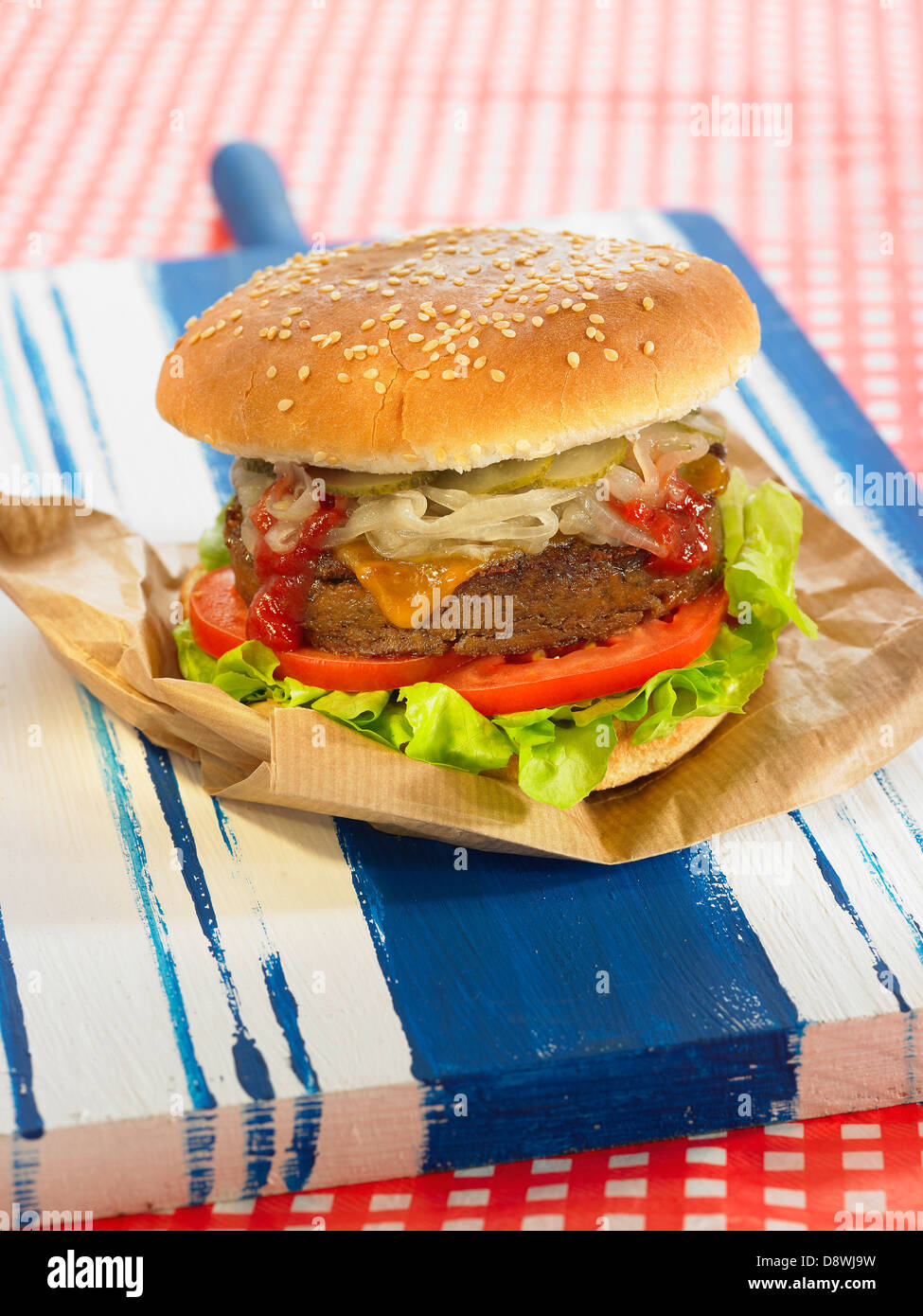 Smoked seitan burger with onions,cheddar,salad and tomatoes Stock Photo