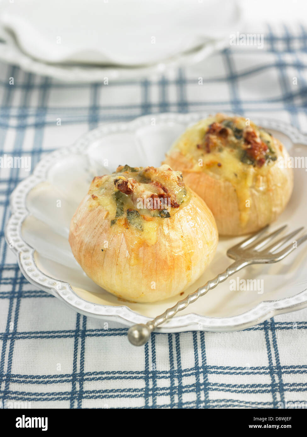 Onions stuffed with emmental,sun-dried tomatoes and spinach Stock Photo