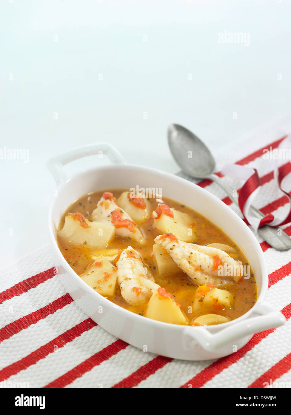 Cod and potato stew in white wine and tomato sauce Stock Photo