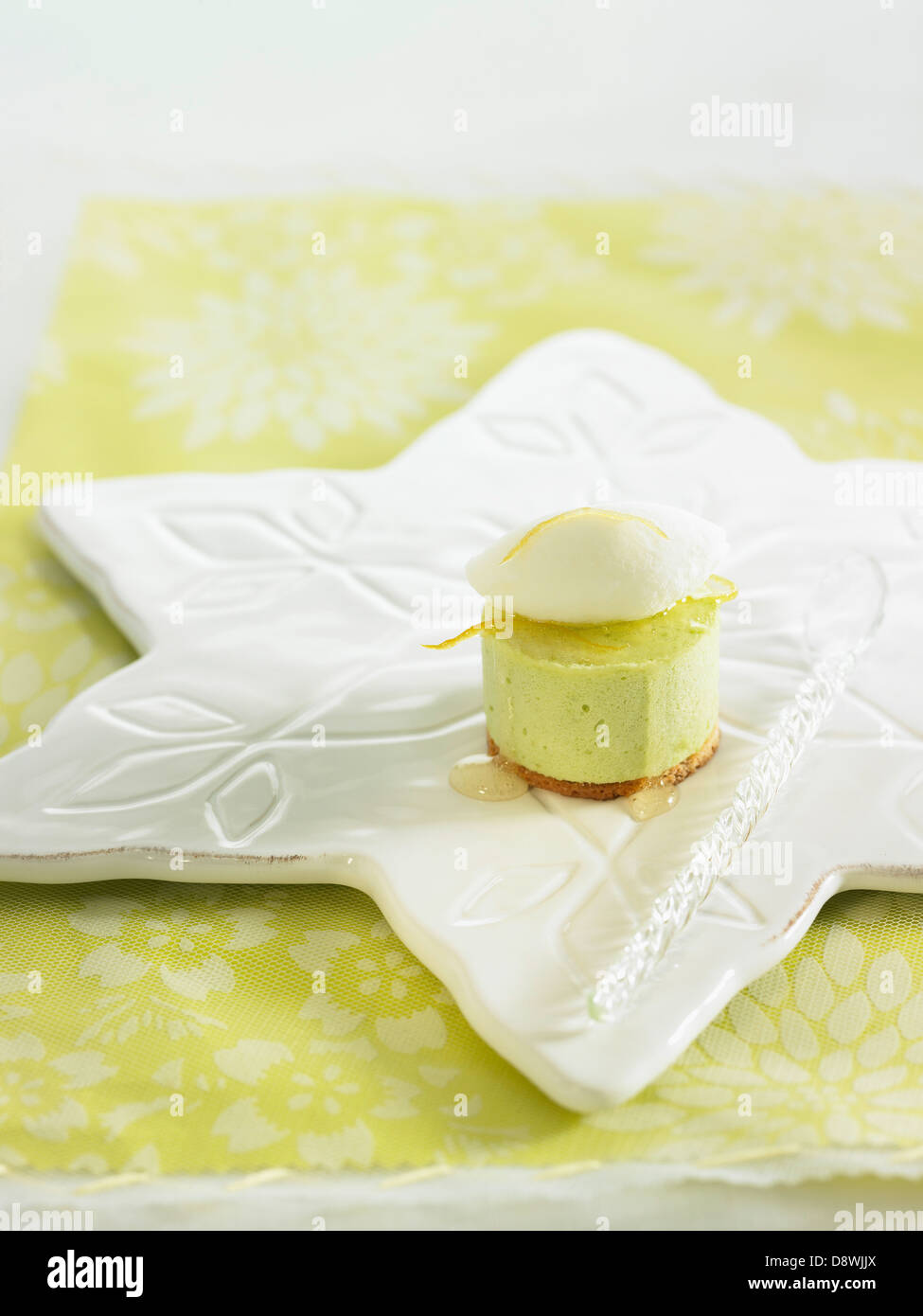 Shortbread and lemon-Granny Smith apple mousse dessert topped with yoghurt ice cream Stock Photo