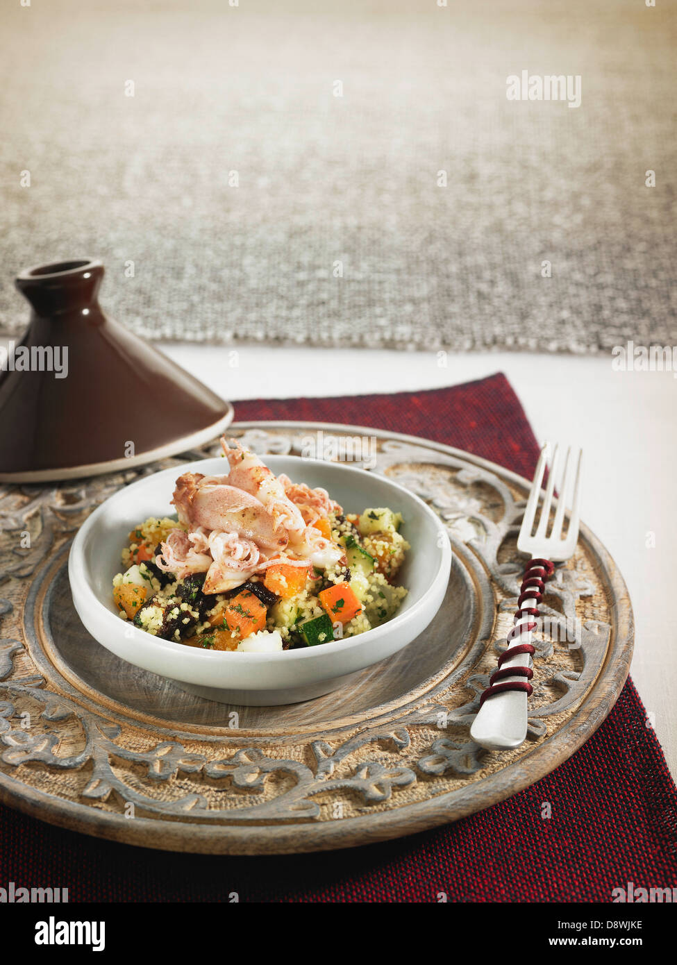 Vegetable Couscous with dried fruit and squid Stock Photo