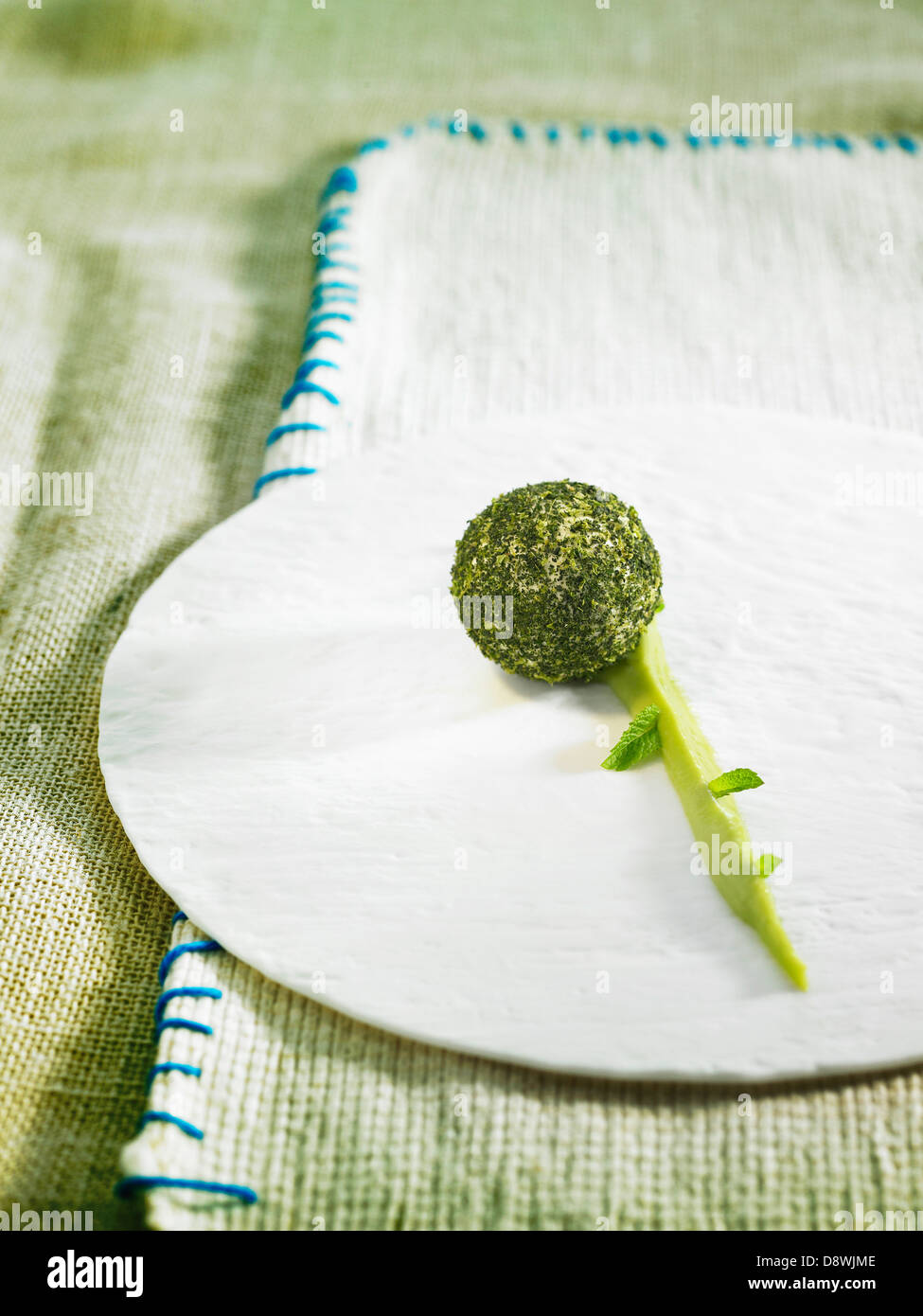 Fromage frais and green tea cheese ball,lime mousse and mint leaves Stock Photo