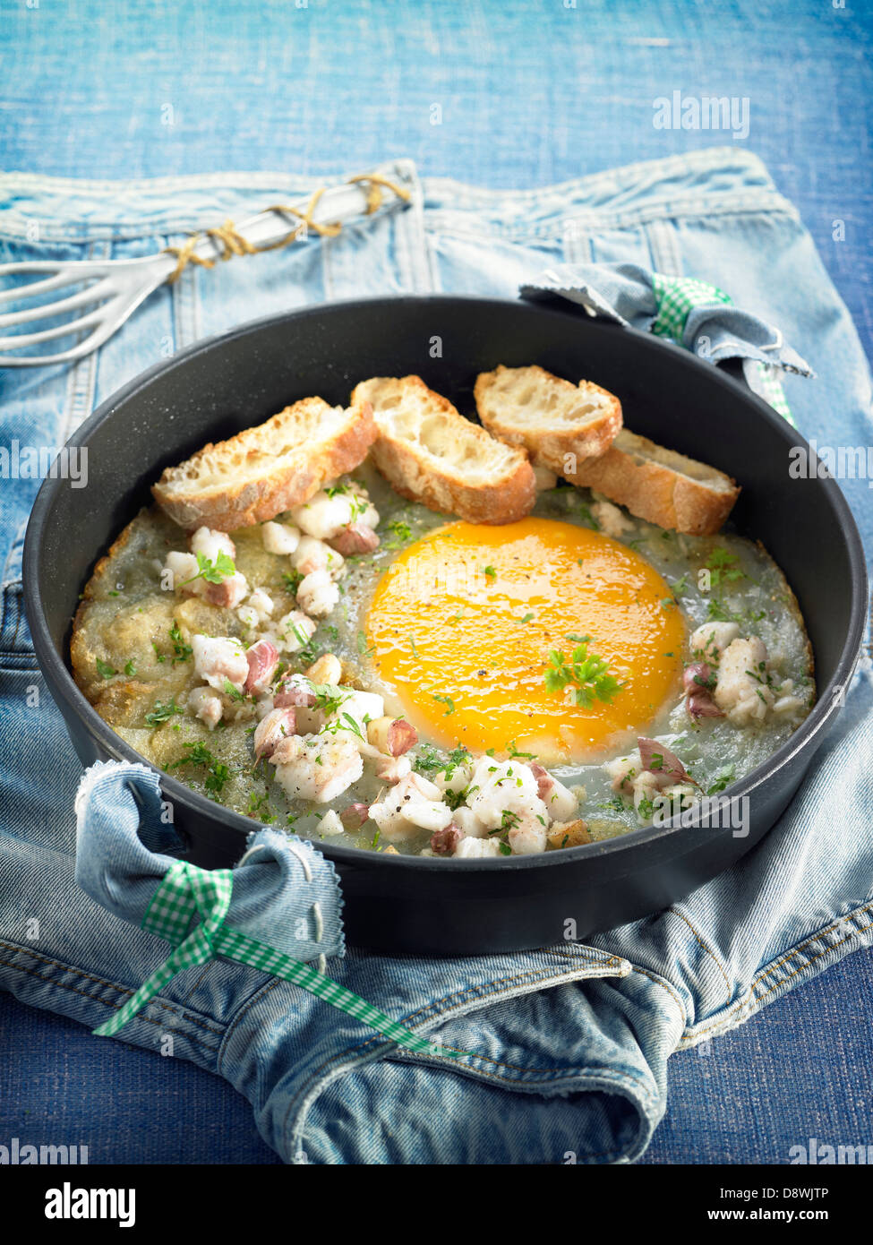 Ostrich omelette with salt-cod,parsley and bread Stock Photo