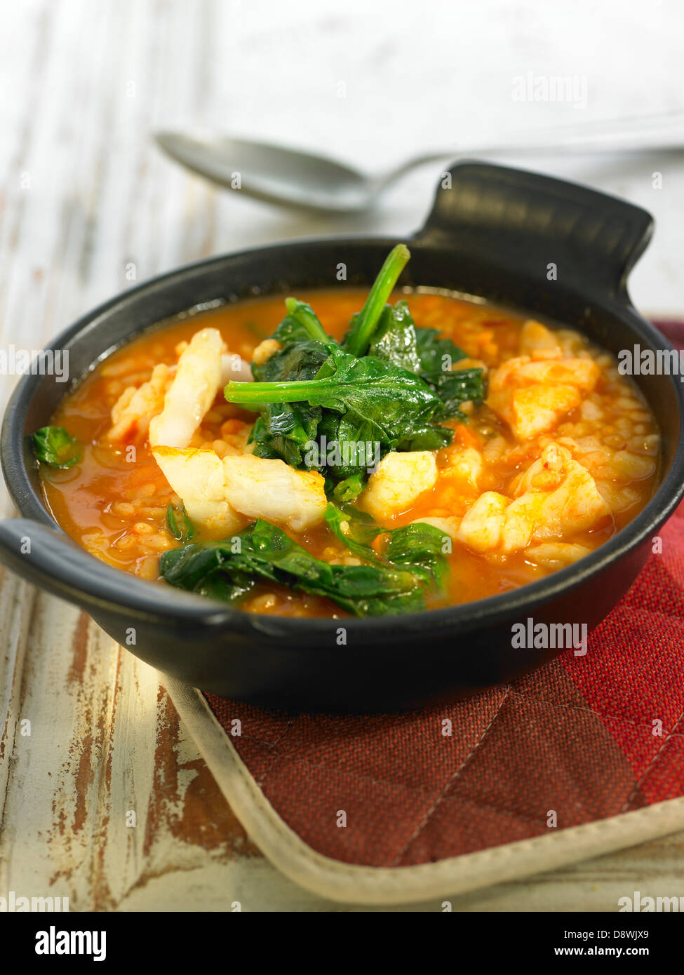 Rice,salt-cod and spinach in tomato sauce Stock Photo