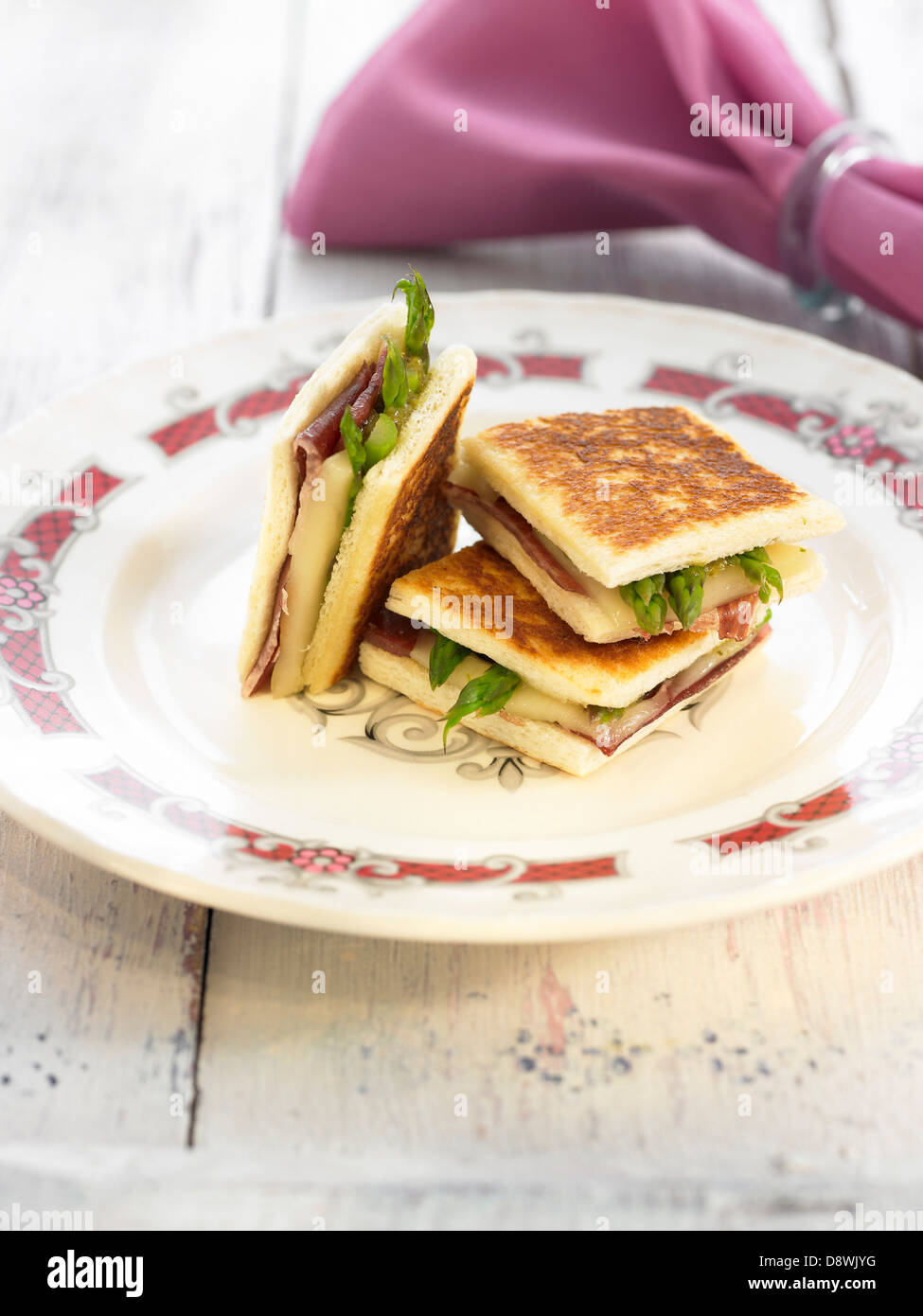 Raw ham,asparagus and melted cheese toasted sandwiches Stock Photo