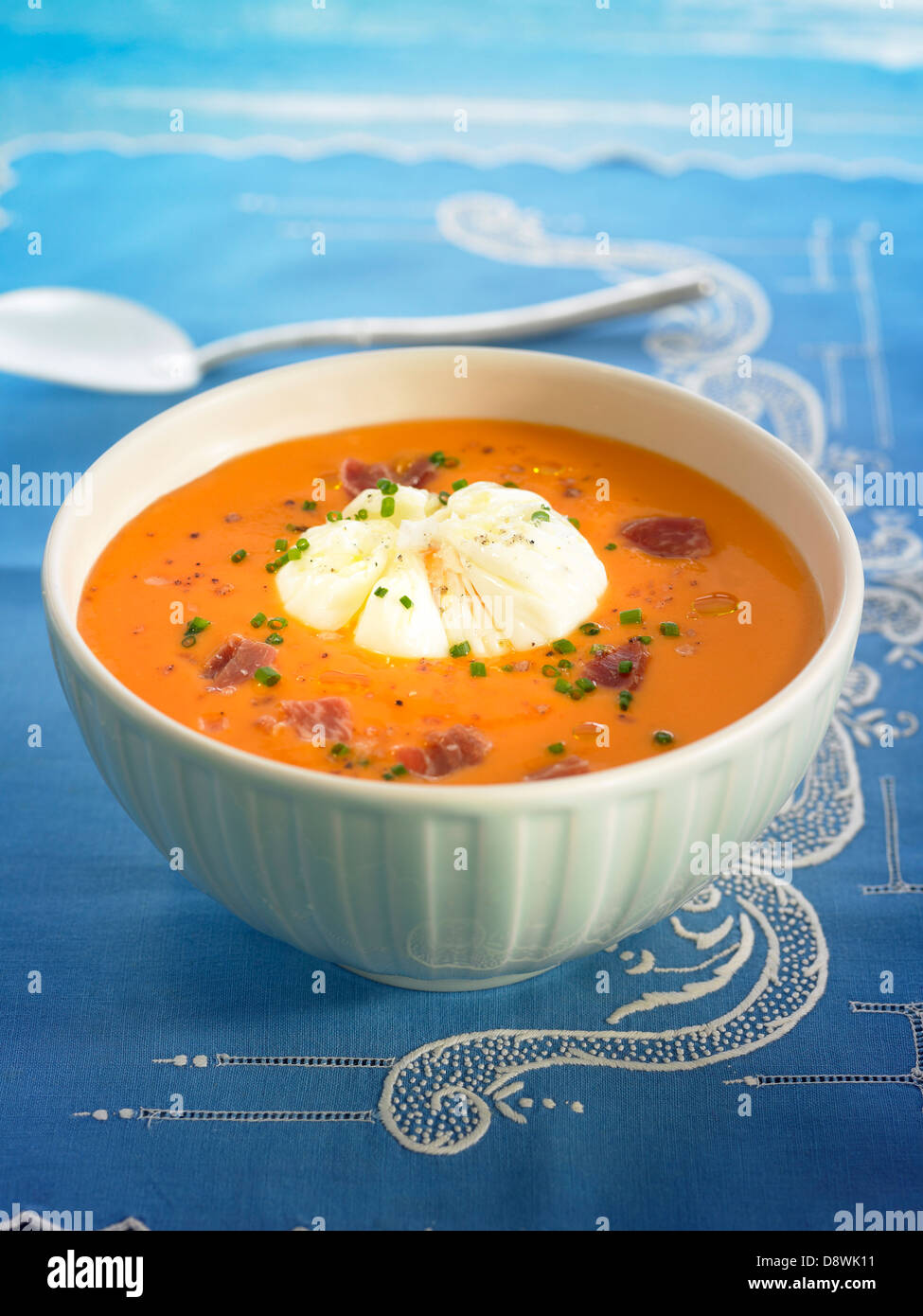 Tomato Salmorejo with diced raw ham and a poached egg Stock Photo