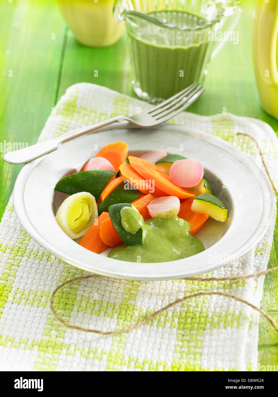 Steamed vegetables with green lentil and coconut milk sauce Stock Photo
