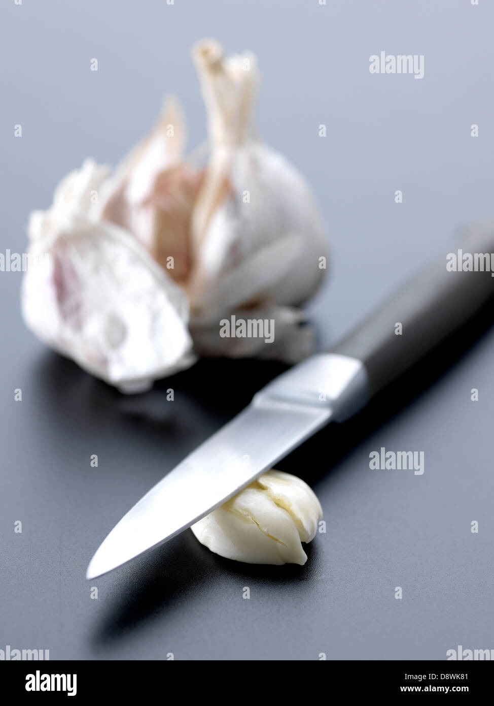 Crushing garlic with a knife Stock Photo Alamy