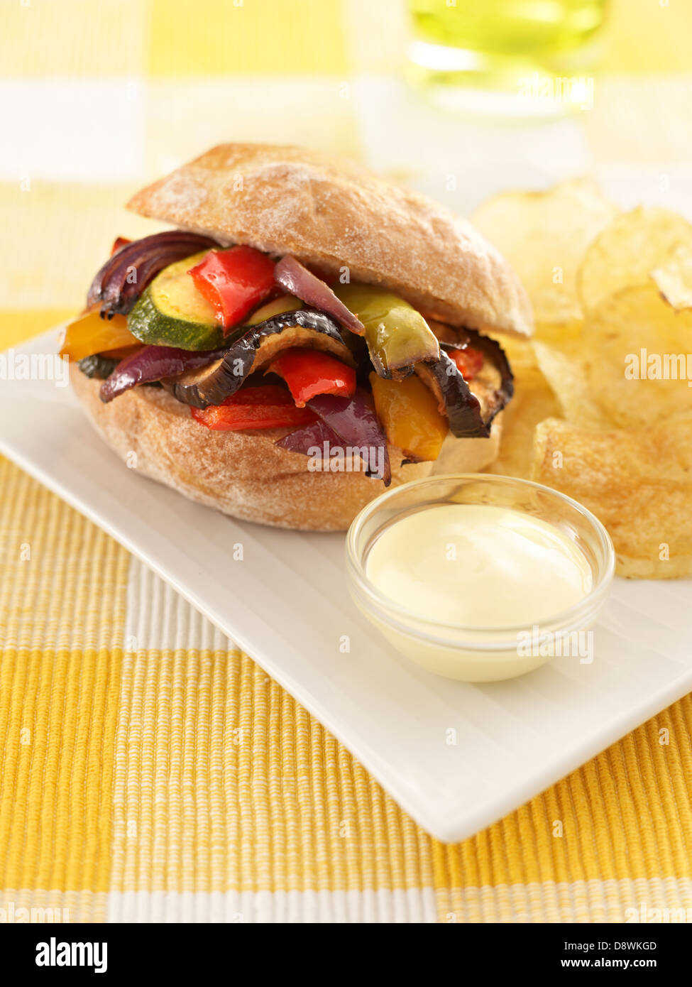 sandwich roll bun vegetable cooked crisps mayonnaise table tablecloth drink Stock Photo