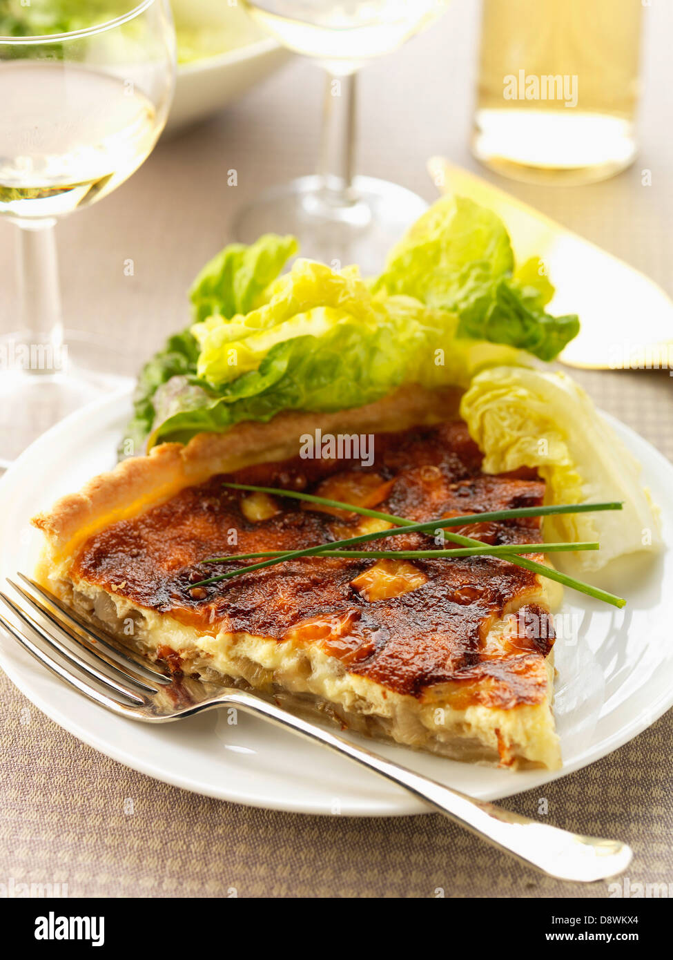 Slice of chicory and Maroilles cheese savoury tart Stock Photo