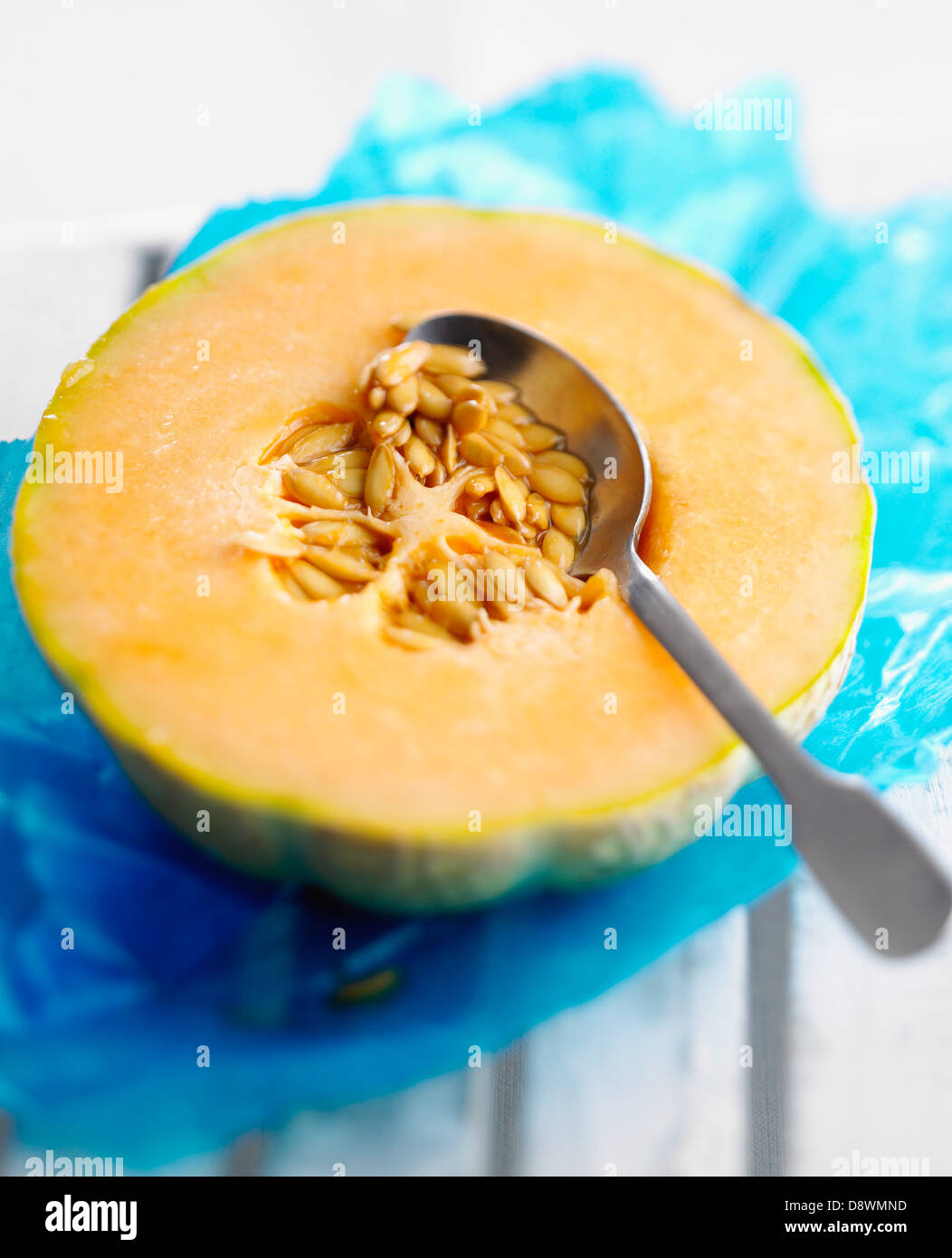 Taking the pips out of half a melon Stock Photo Alamy