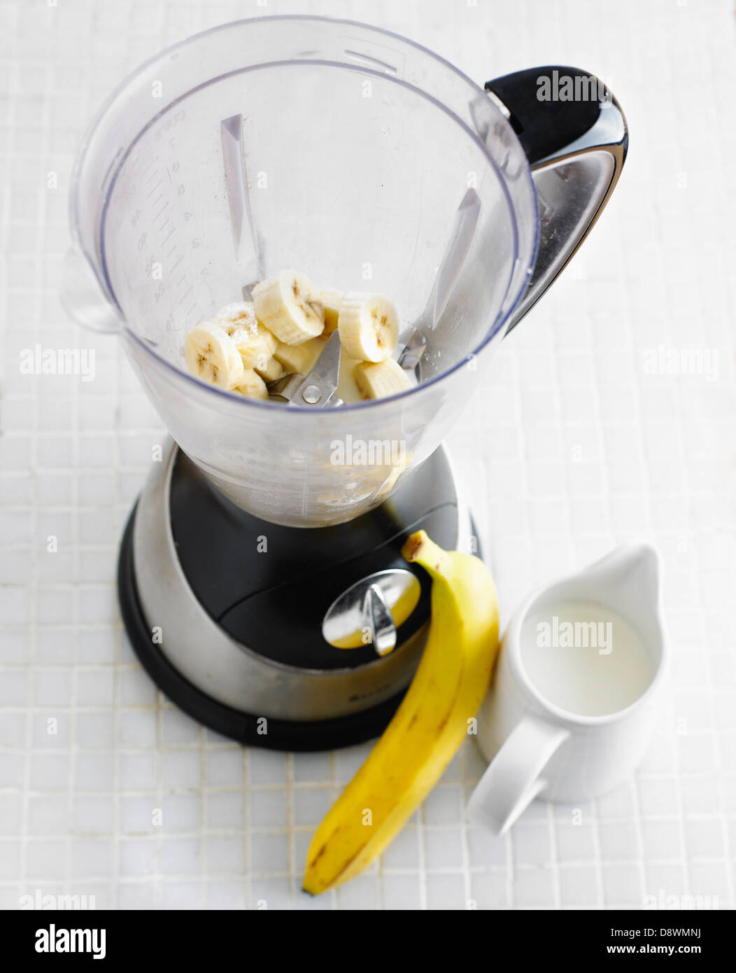Preparing a banana milkshake in a blender Stock Photo Alamy
