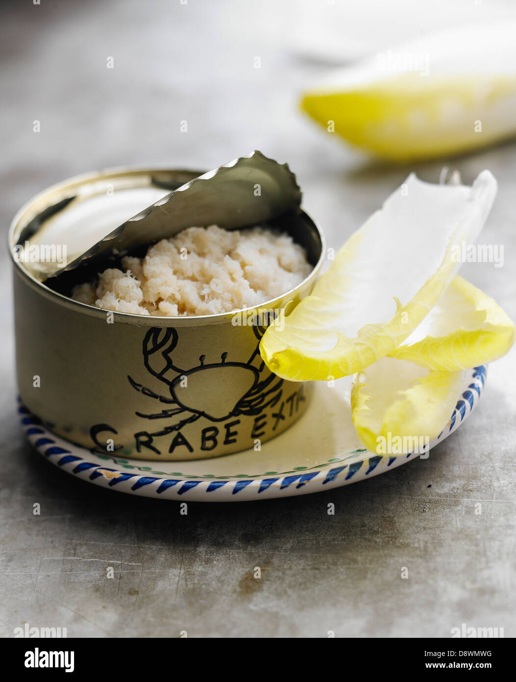 Can of flaked crab meat and chicory leaves Stock Photo Alamy
