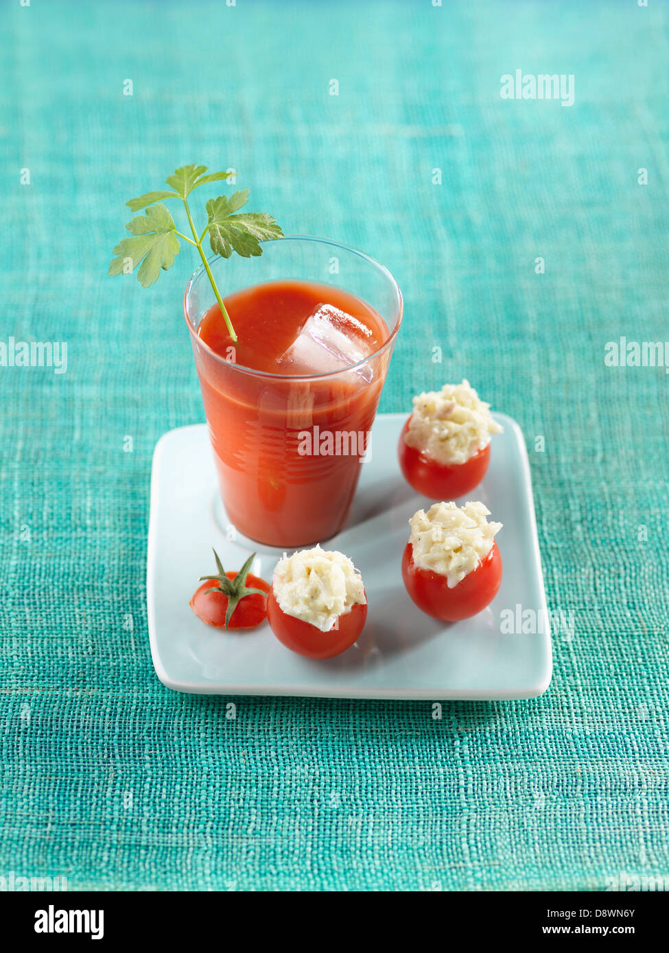 Bloody Mary cocktail and cherry tomatoes stuffed with salt-cod Stock Photo