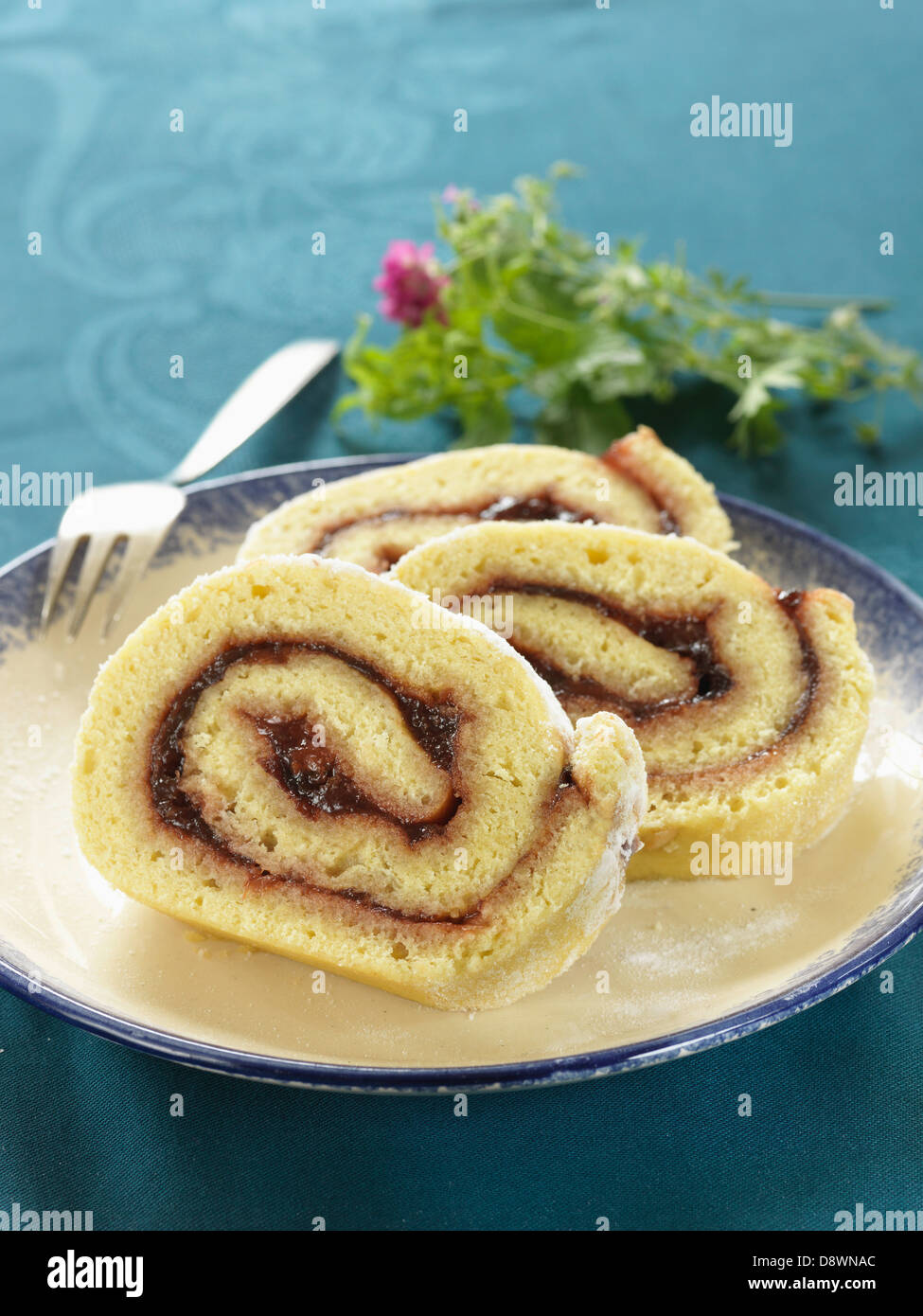 Rolled sponge cake with plum jam filling Stock Photo Alamy