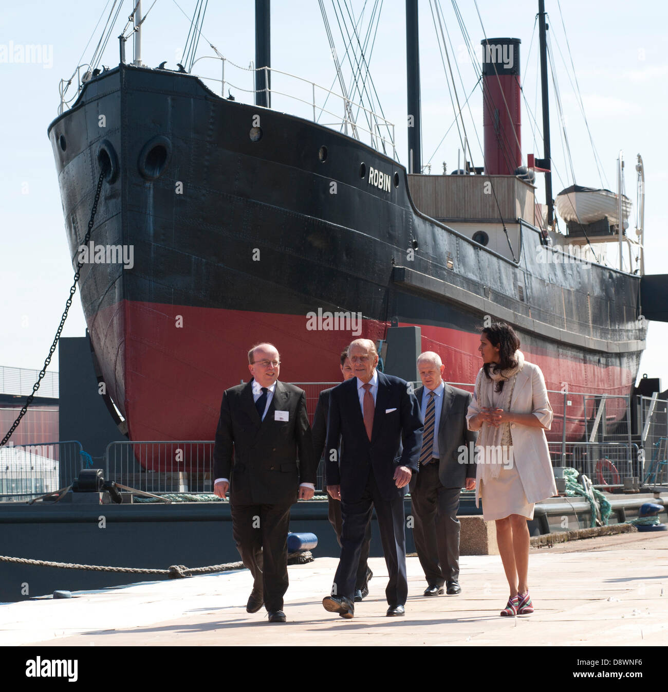 London, UK. 5th June, 2013. SS Robin, the world's oldest complete streamship visited by HRH Prince Philip the Honorary Member of the SS Robin trust, who will be 92 on June 10th 2013. Prince Philip only a few days short of his 92nd birthday paid a visit to the SS Robin at the launch of 'Open Doors' the final phase of a 5 year £3 Million restoration project masterminded by David and Nish Kampfner sear £3 Million restoration project masterminded by David and Nish Kampfner seen here on right in white. the SS Robin is berthed at London Victoria docks for final fitting out.  © BRIAN HARRIS/Alamy Liv Stock Photo