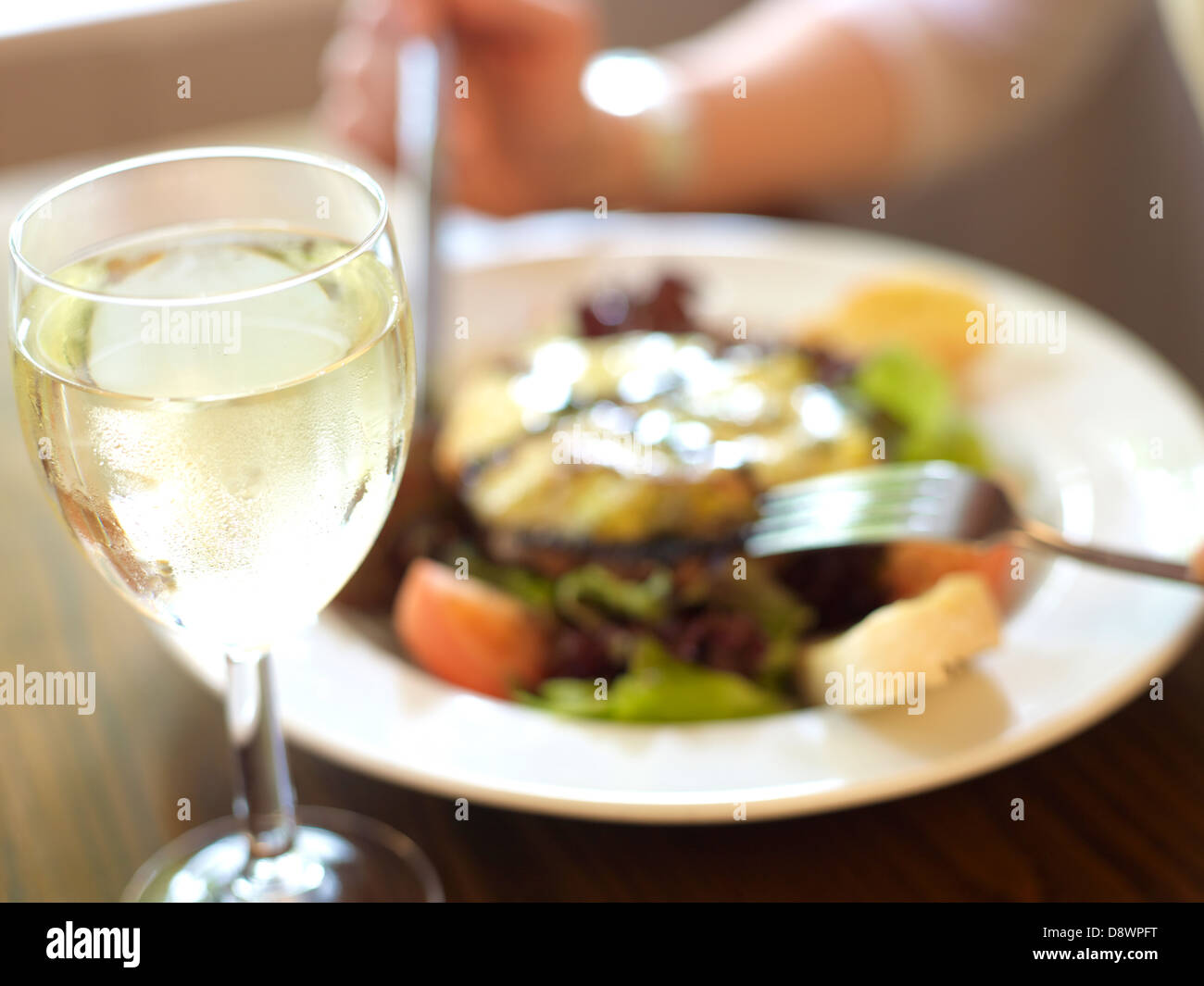 dinner lunch wine glass salad fork knife hand Stock Photo