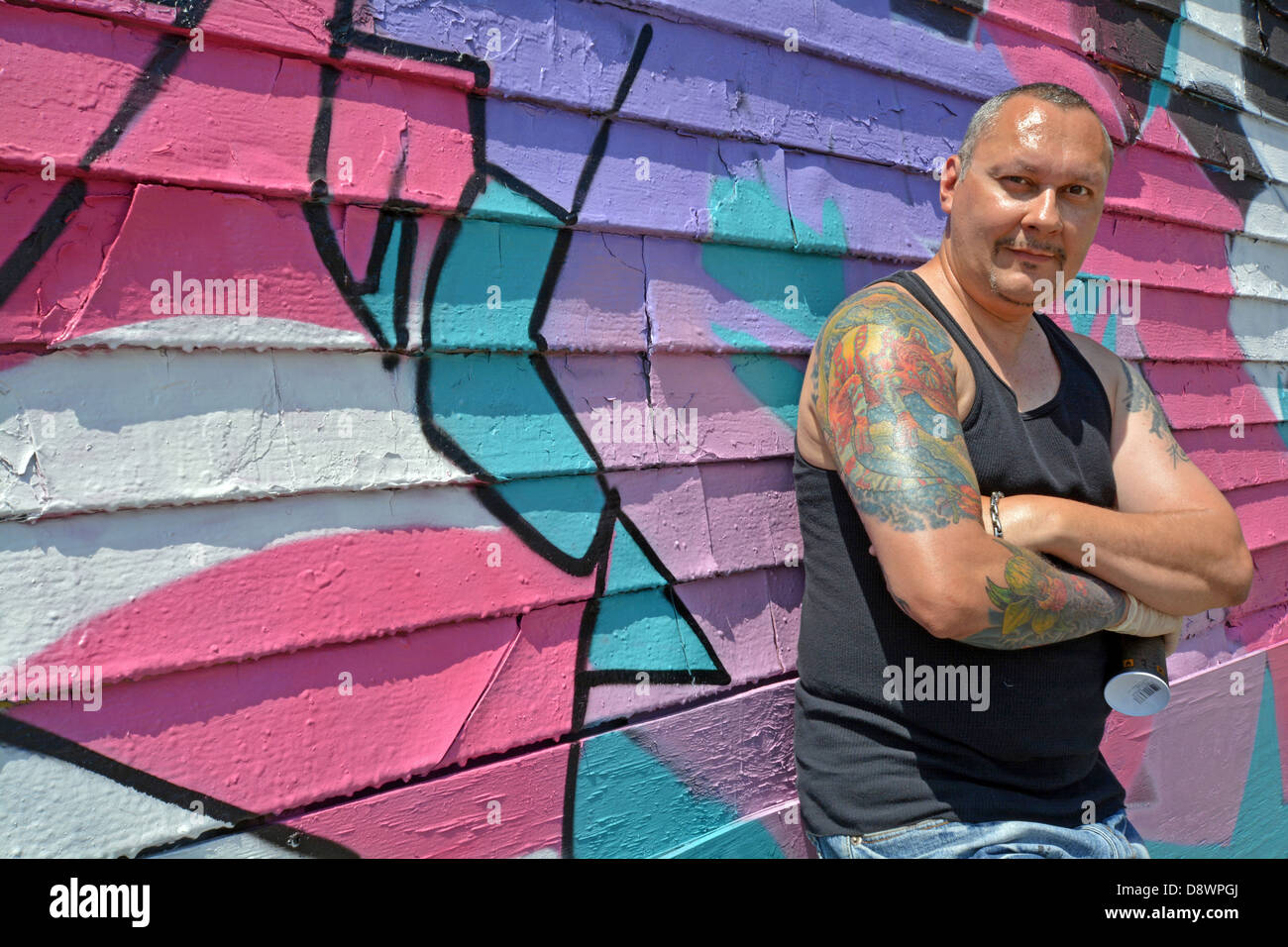 Portrait of world famous graffiti artist in front of his work at 5