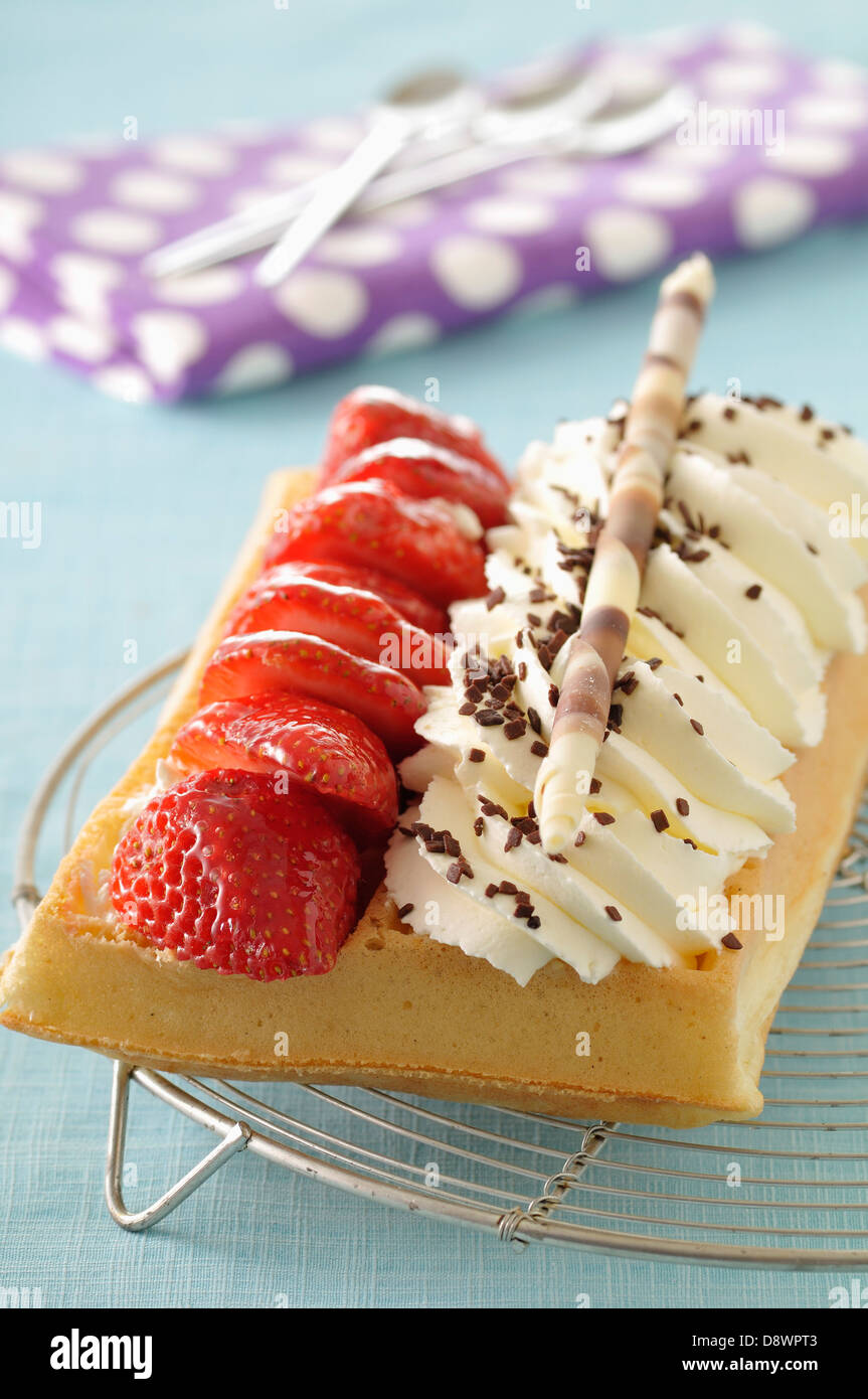 Waffle with whipped cream and strawberries Stock Photo - Alamy