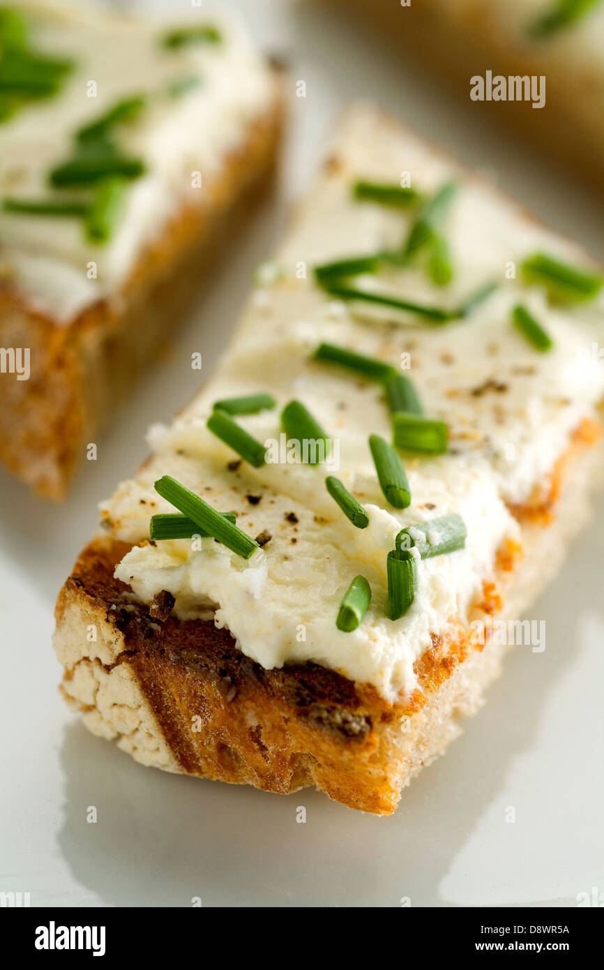 Creamy mascarpone with chives on mini toasts Stock Photo - Alamy