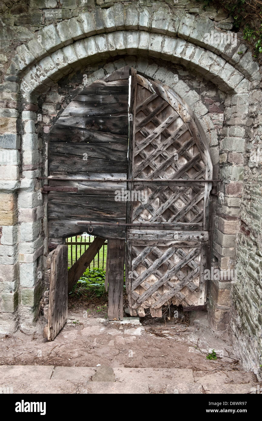 The early 13c entrance to Hay Castle, Hay-on-Wye, UK, with an open wicket gate. The criss-cross pattern strengthened the gates against attack Stock Photo