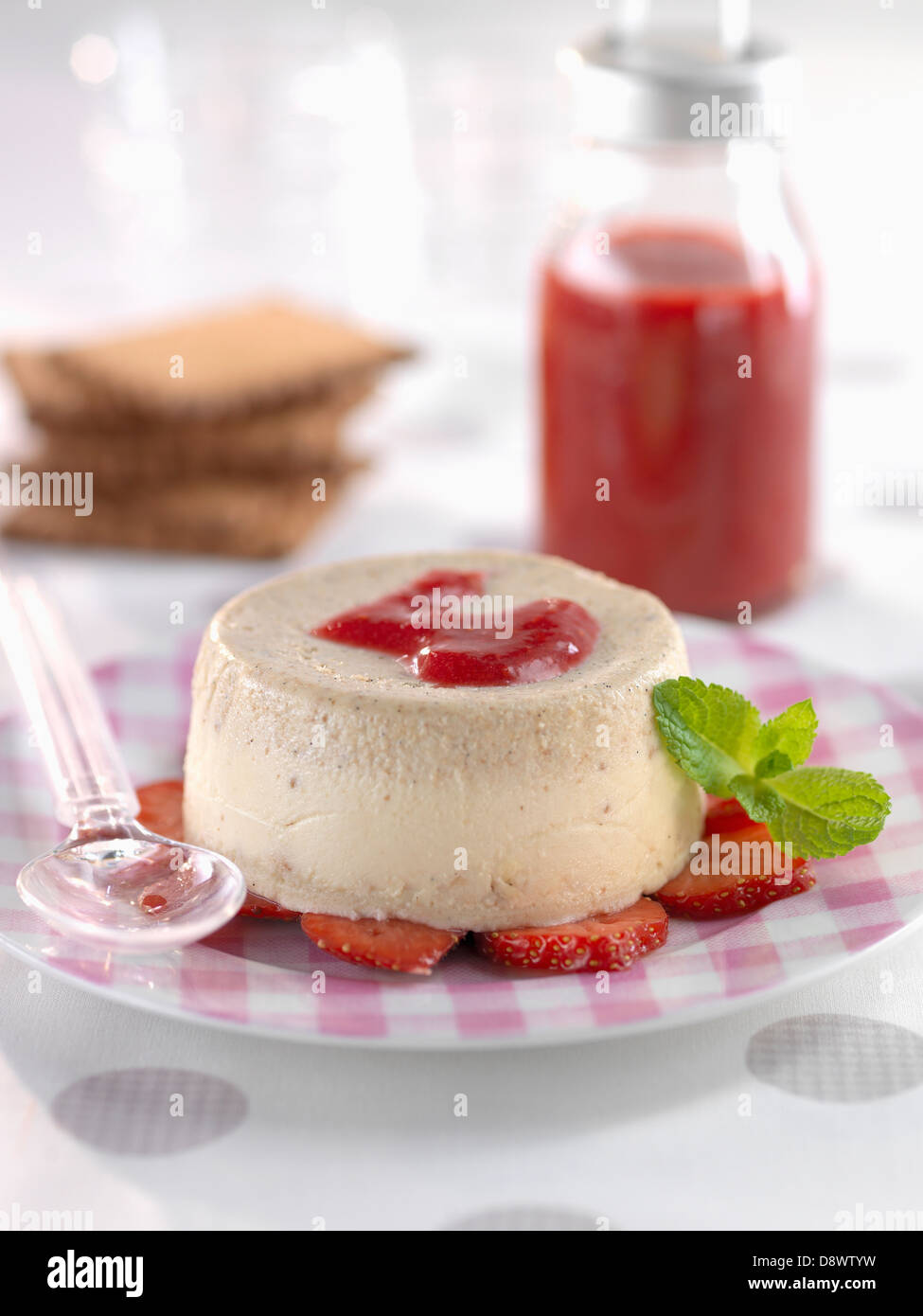 Rich tea biscuit panna cotta with strawberry-raspberry puree Stock Photo