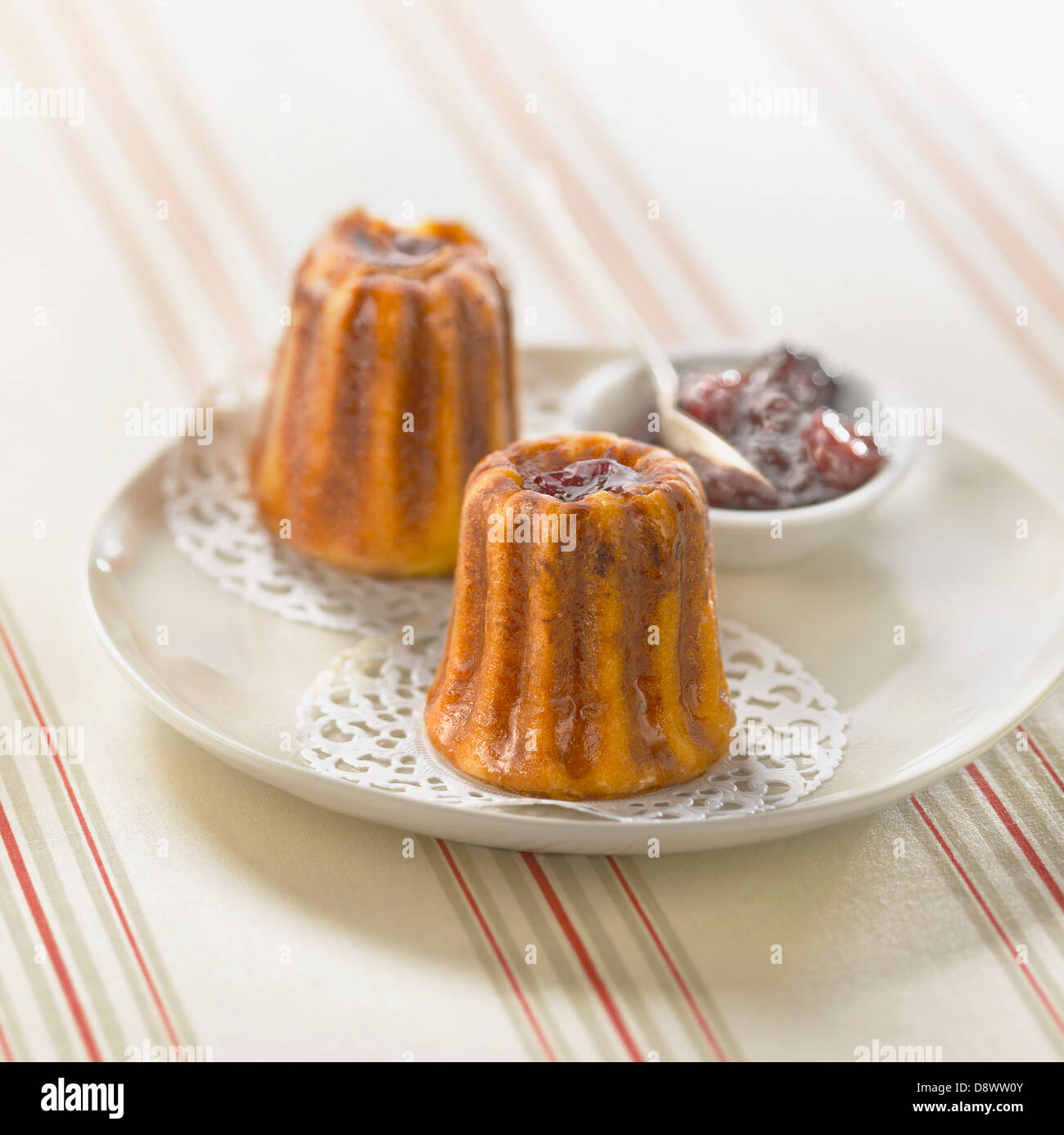 Ewe's cheese Cannelés with black cherry jam Stock Photo