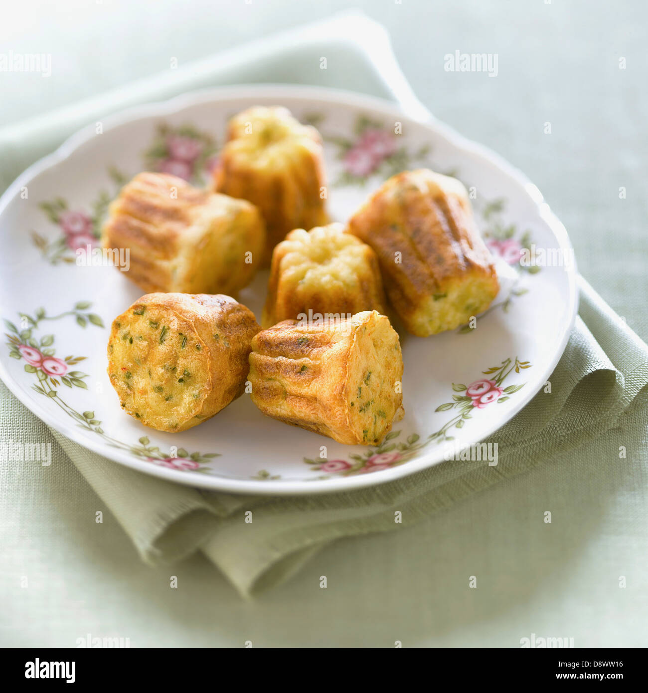 Crab and chive Cannelés Stock Photo