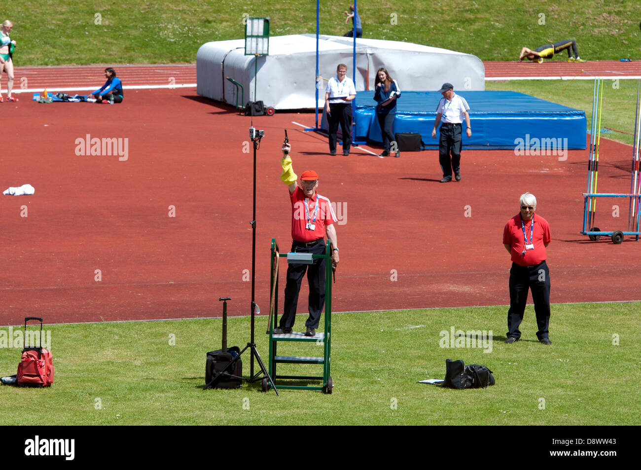 Athletics, starter holding up pistol Stock Photo Alamy