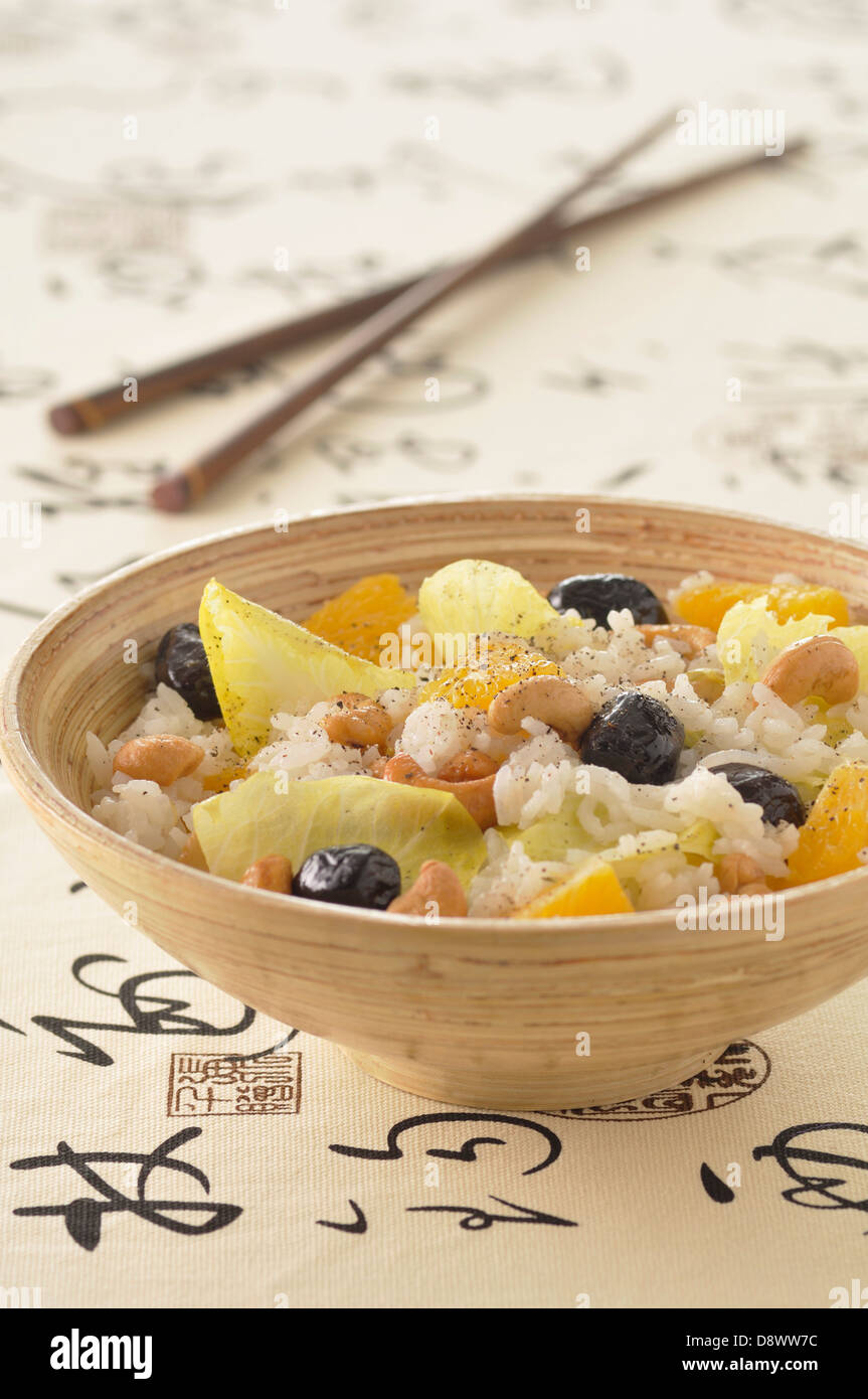 Thai rice salad with cashews,oranges,chicory and black olives Stock Photo