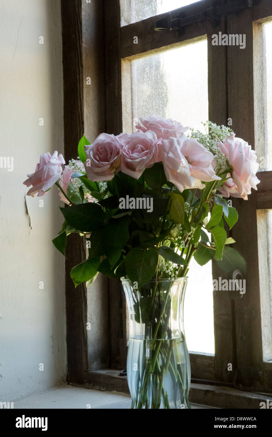 Bouquet of roses on the old windowsill with wooden window frames Stock ...
