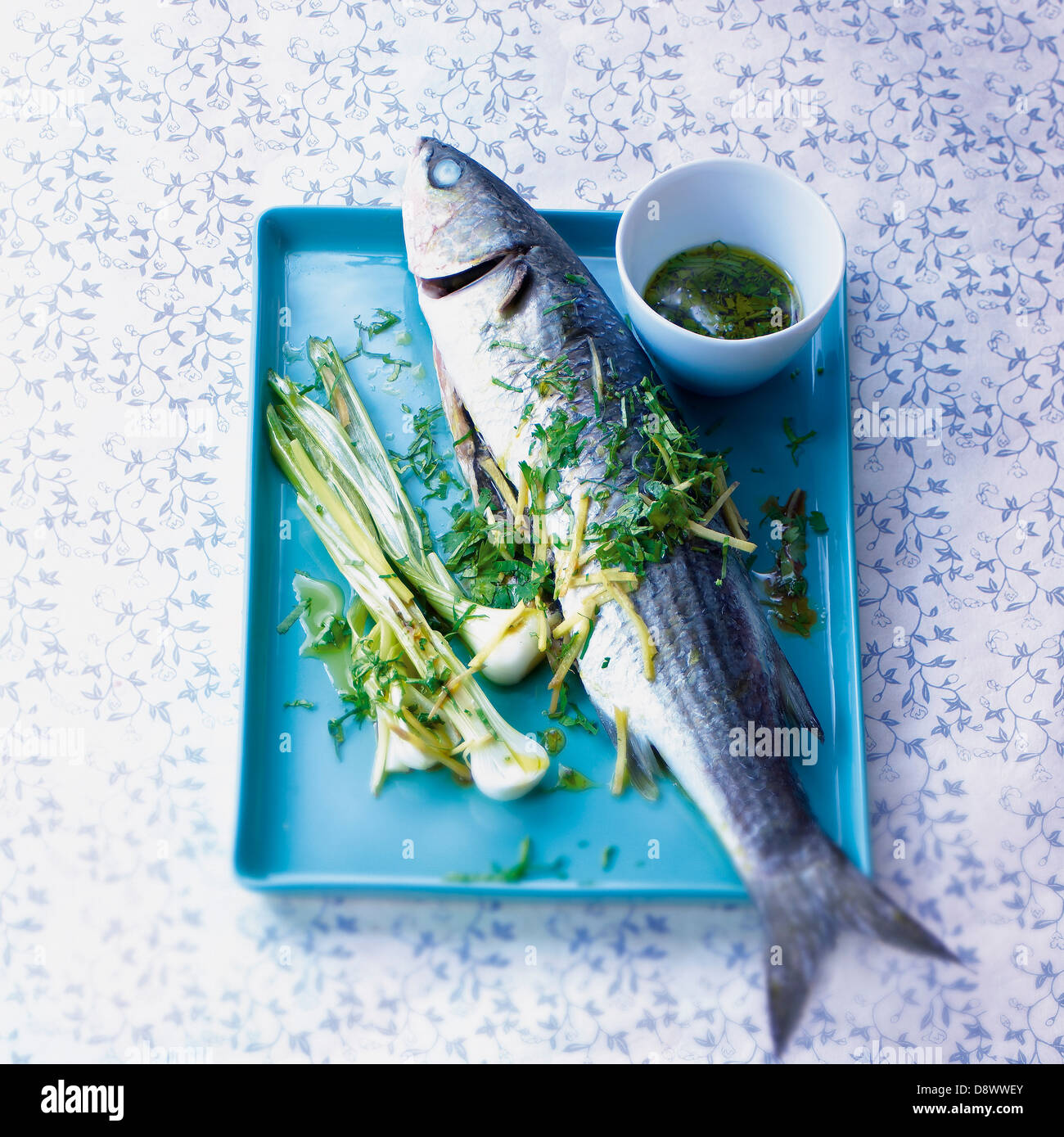 Mullet with spring onions and herb vinaigrette Stock Photo - Alamy