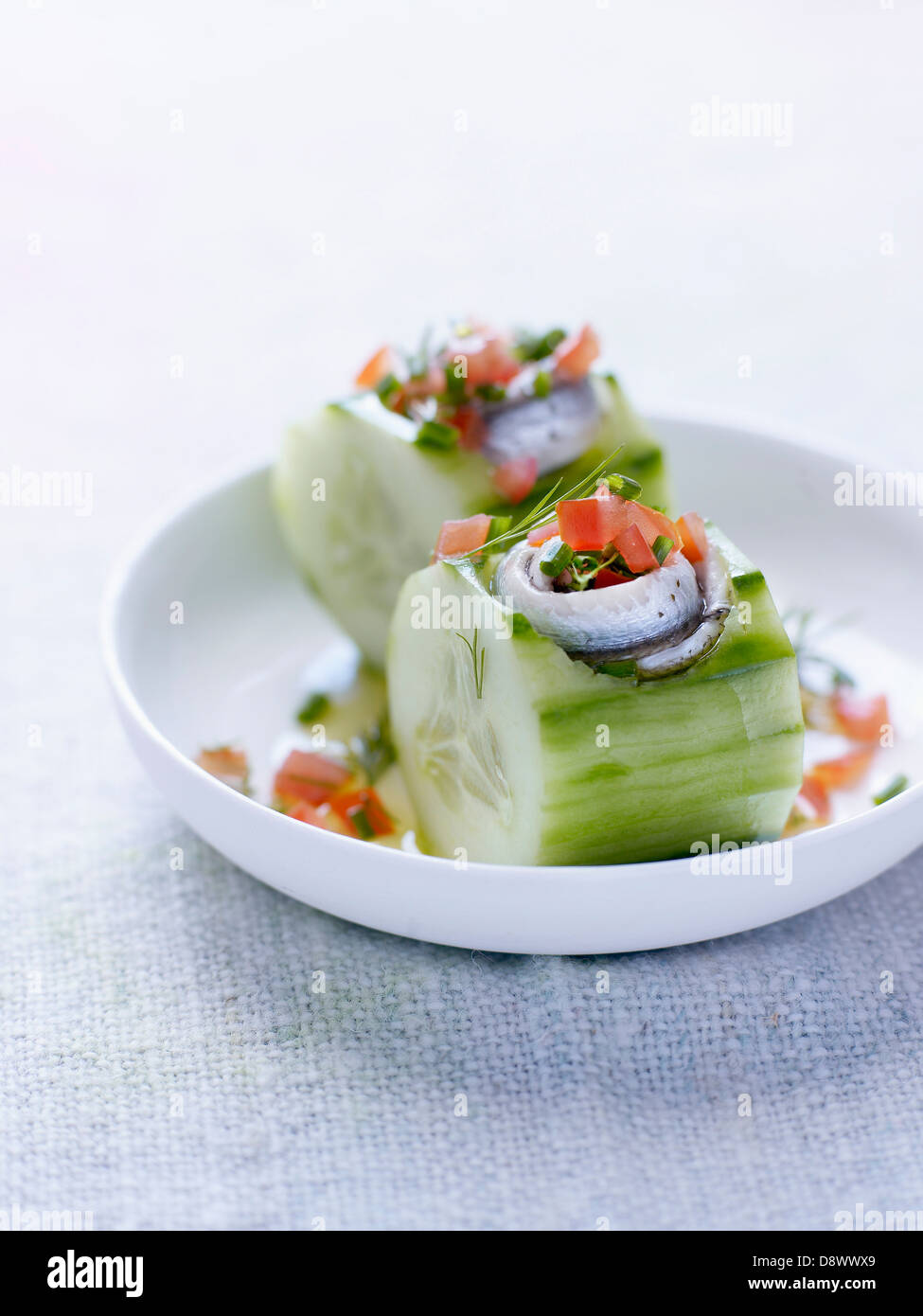 Cucumber with anchovies and diced tomatoes Stock Photo