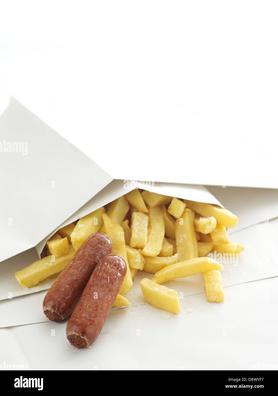 two sausages sausage chips in paper takeaway Stock Photo